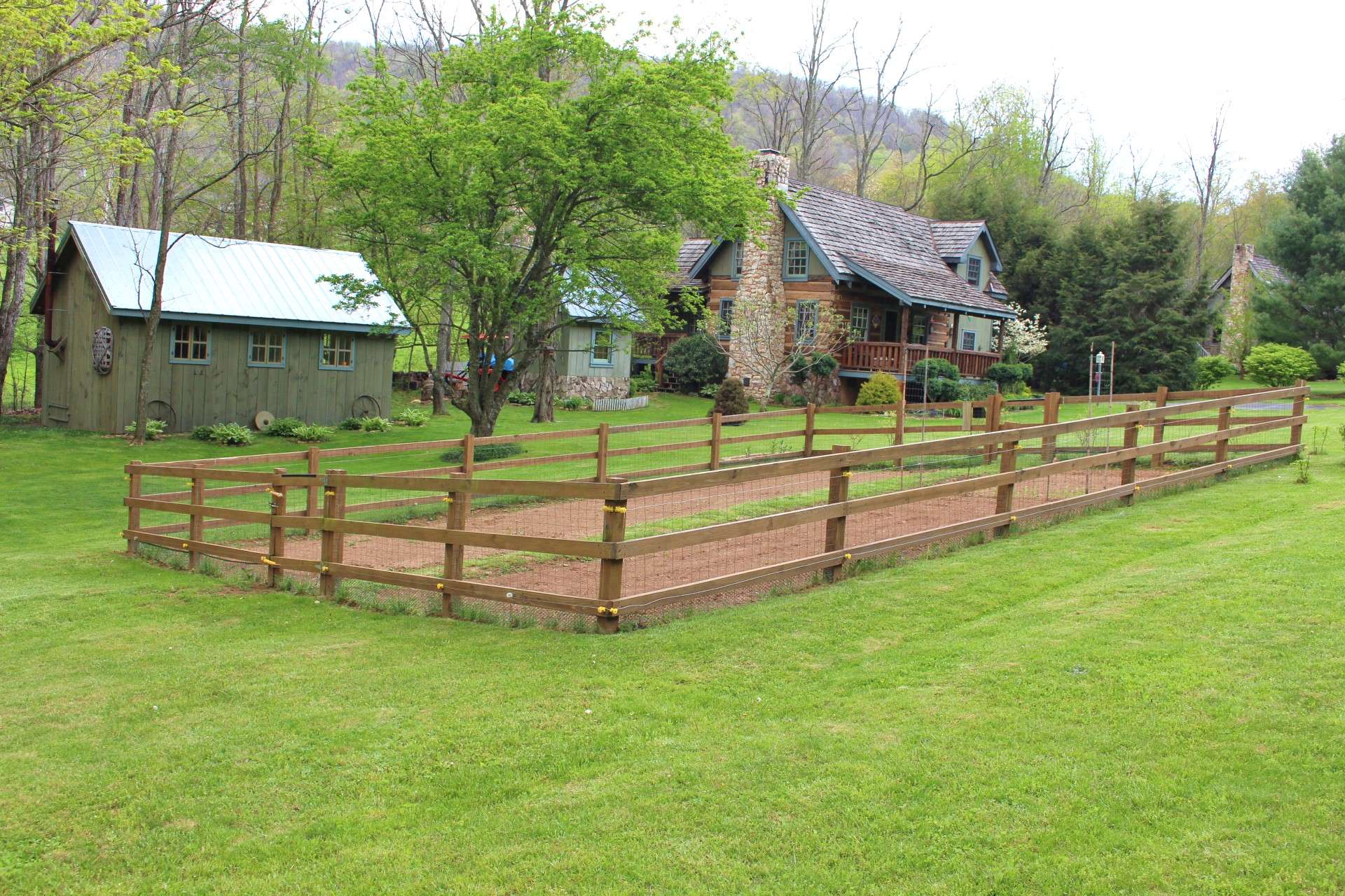 The peaceful setting includes the cabin, nice yard with noisy creek, a craftsman style workshop, outbuilding and views of Bluff Mountain.