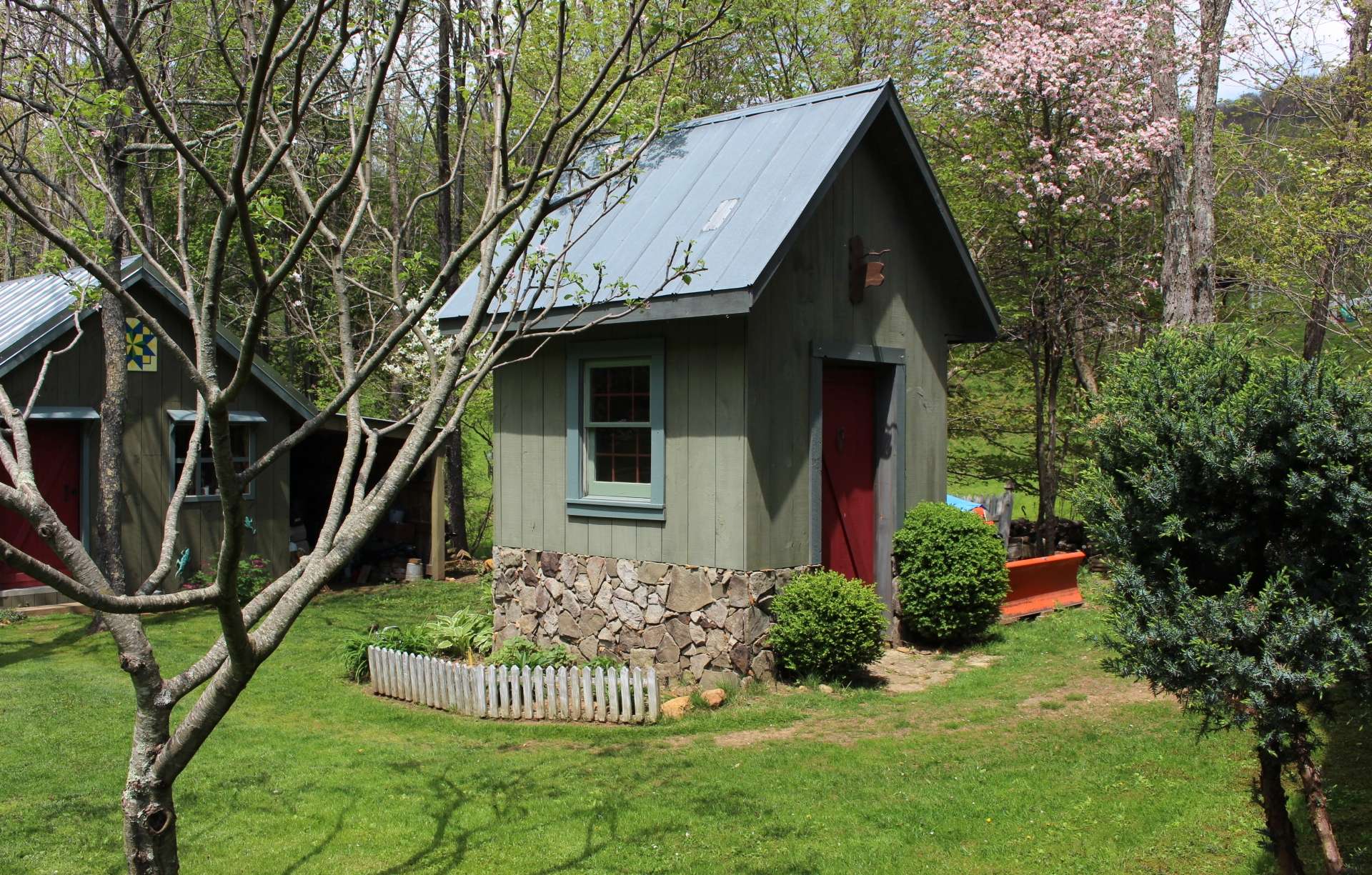 This cute milk room outbuilding will work nicely as storage or potting shed.