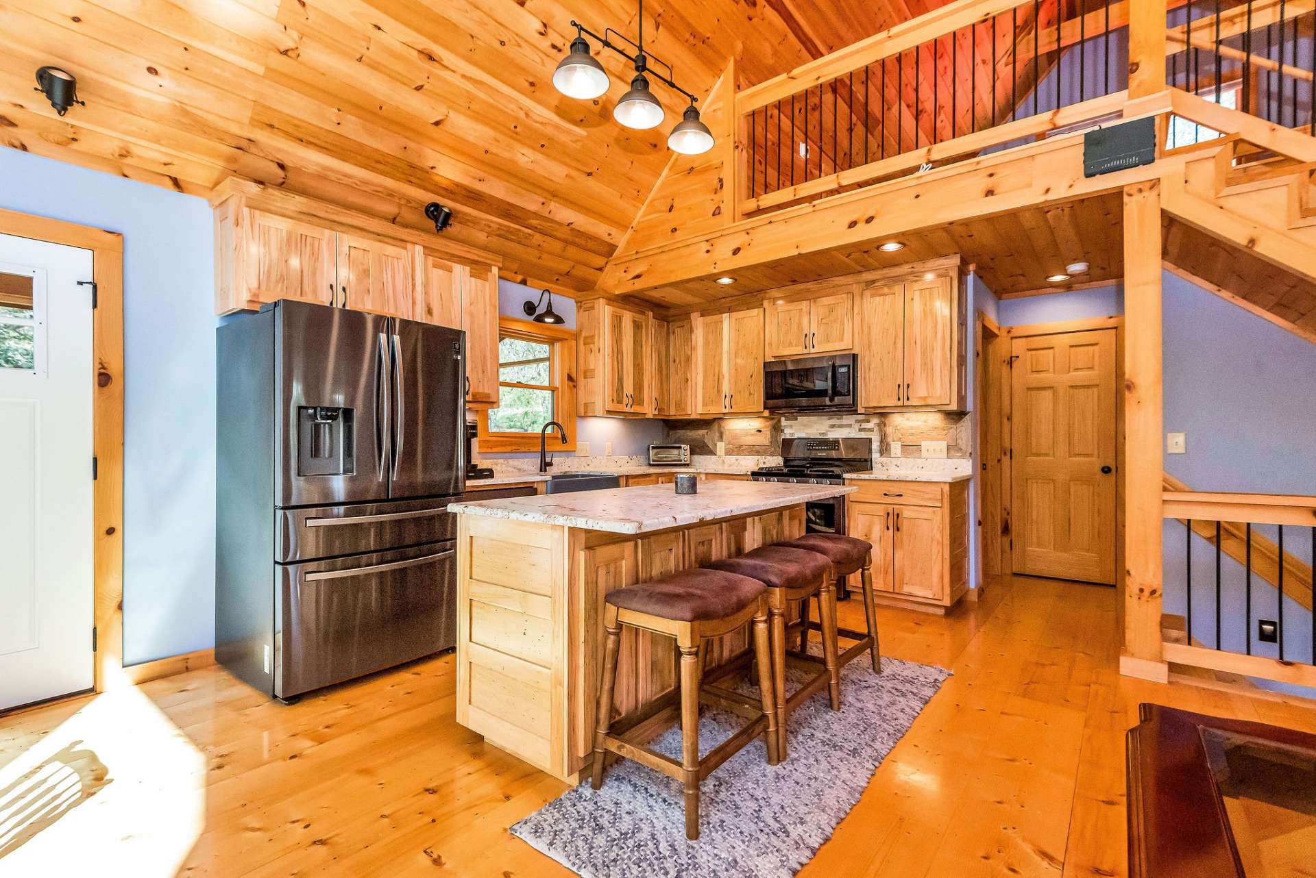 The kitchen strikes the perfect balance between rustic charm and modern convenience, providing a stylish and functional space where cooking, dining, and socializing harmonize effortlessly.