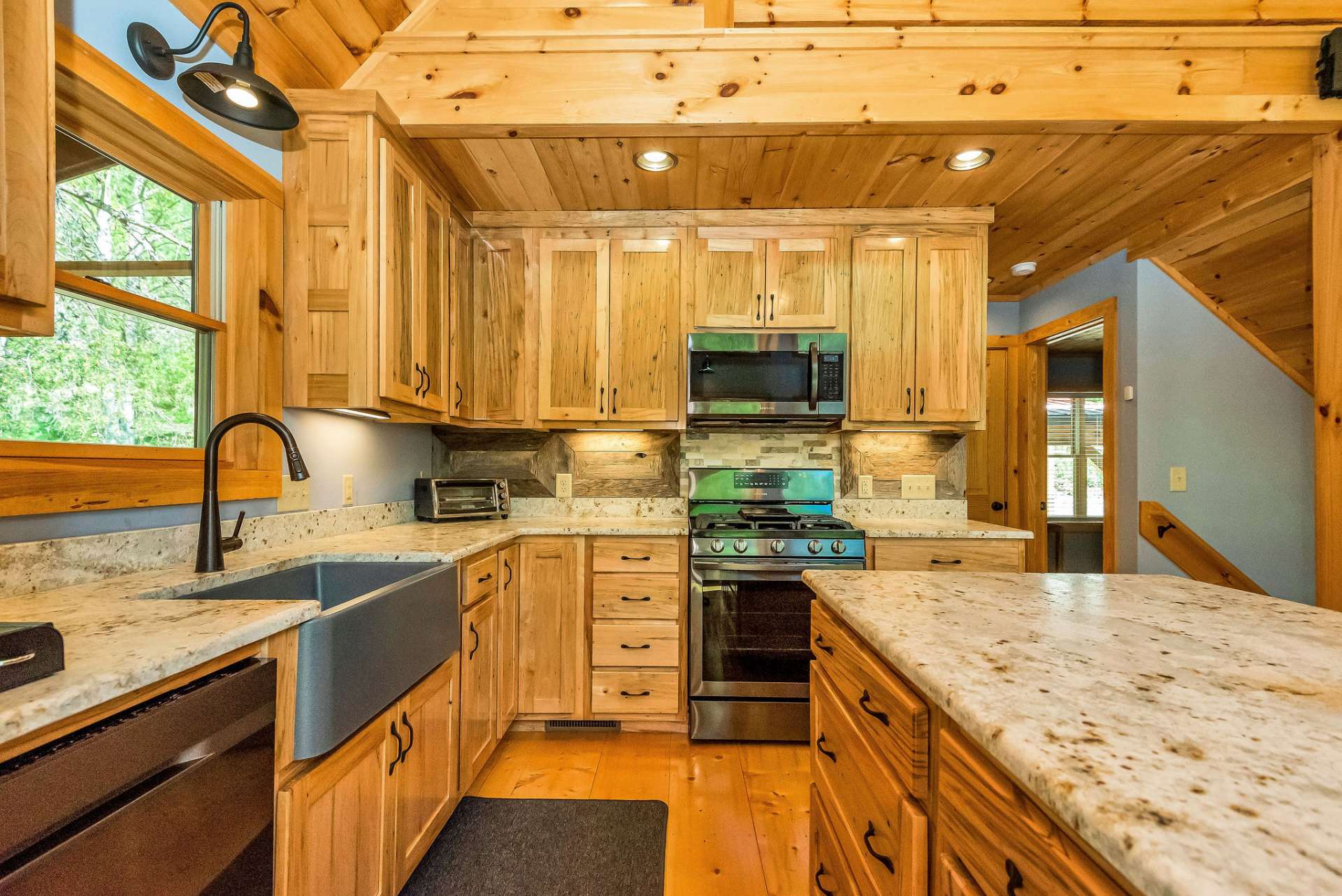 Additional barn wood accents in the kitchen further enhance the rustic charm of the design, adding a unique twist to the overall aesthetic.