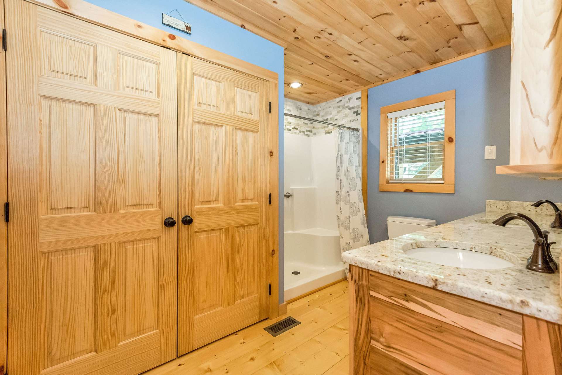 The main level bath features a laundry closet and walk in shower with seating.