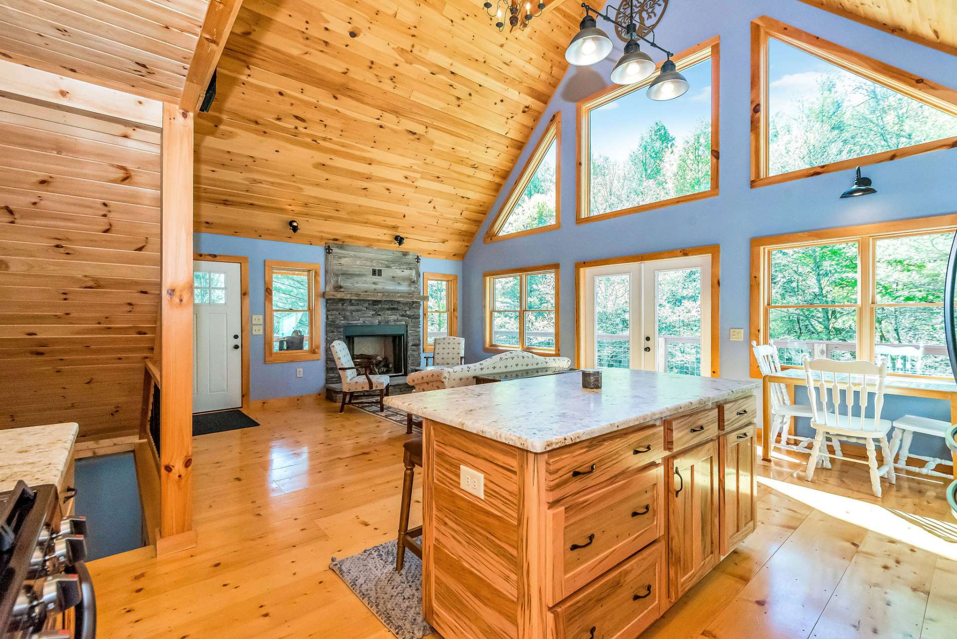 The island gives division between the kitchen and living room, plus provides a serving area, additional storage, and seating.