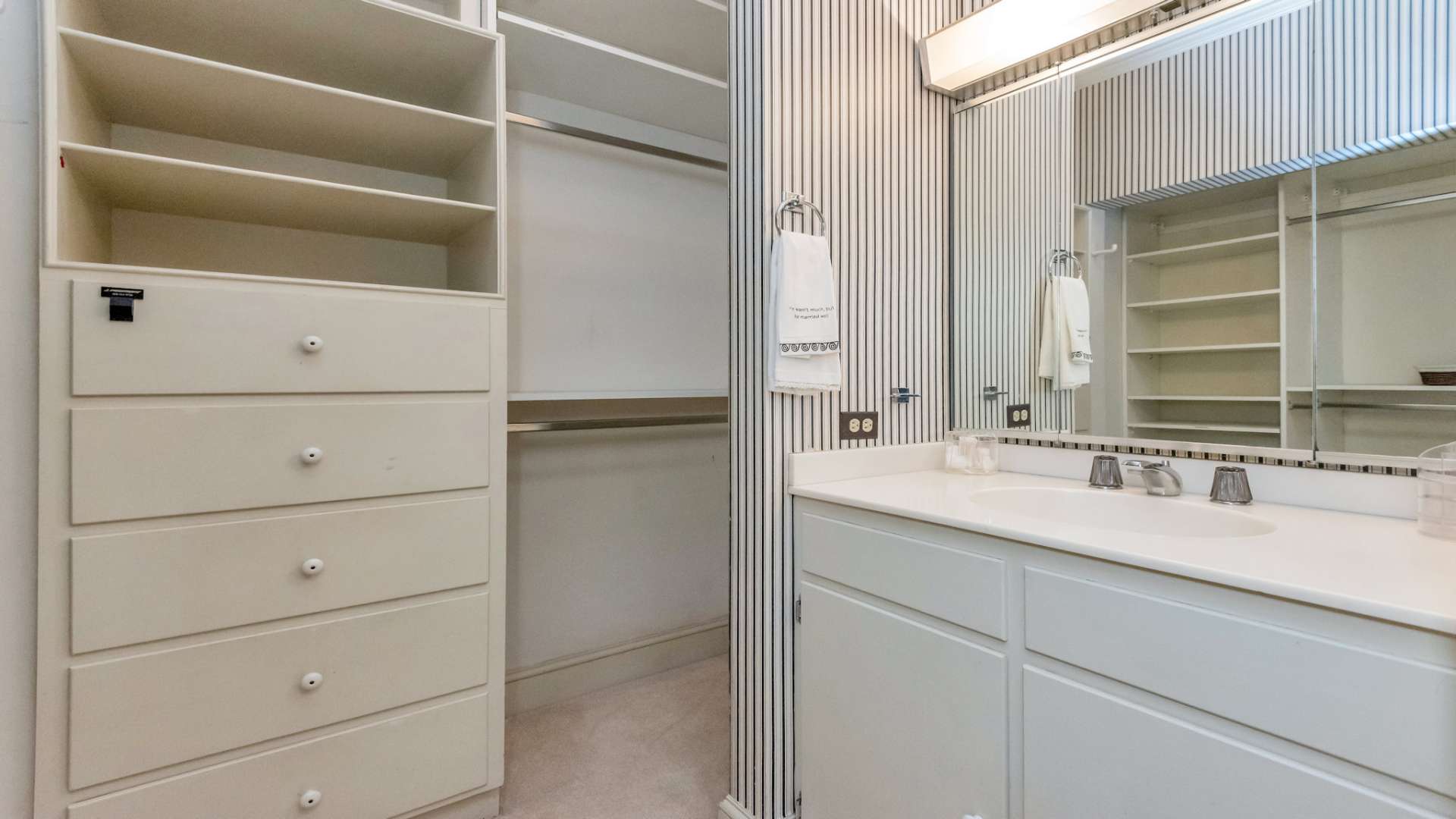 Walk-in closet dressing area with shaving sink.