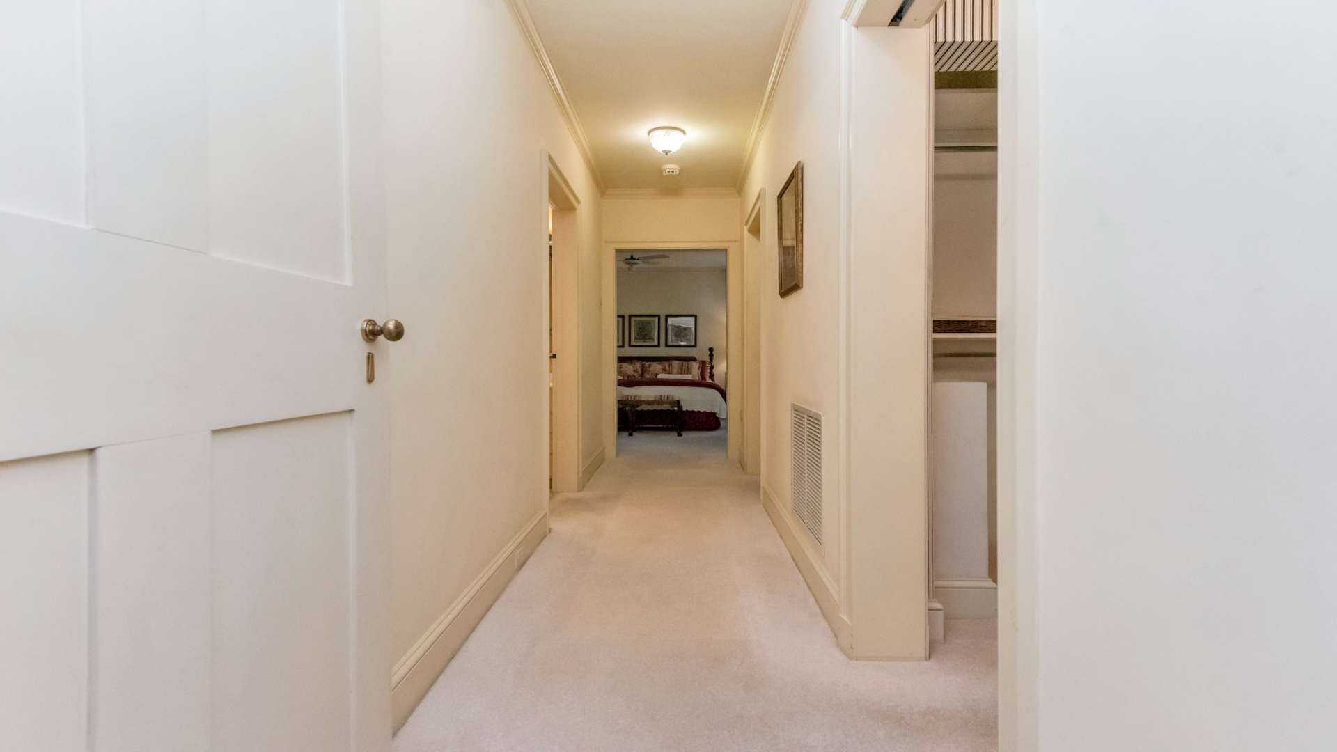 A guest half bath is located down the hall of the main level leading to the primary suite.