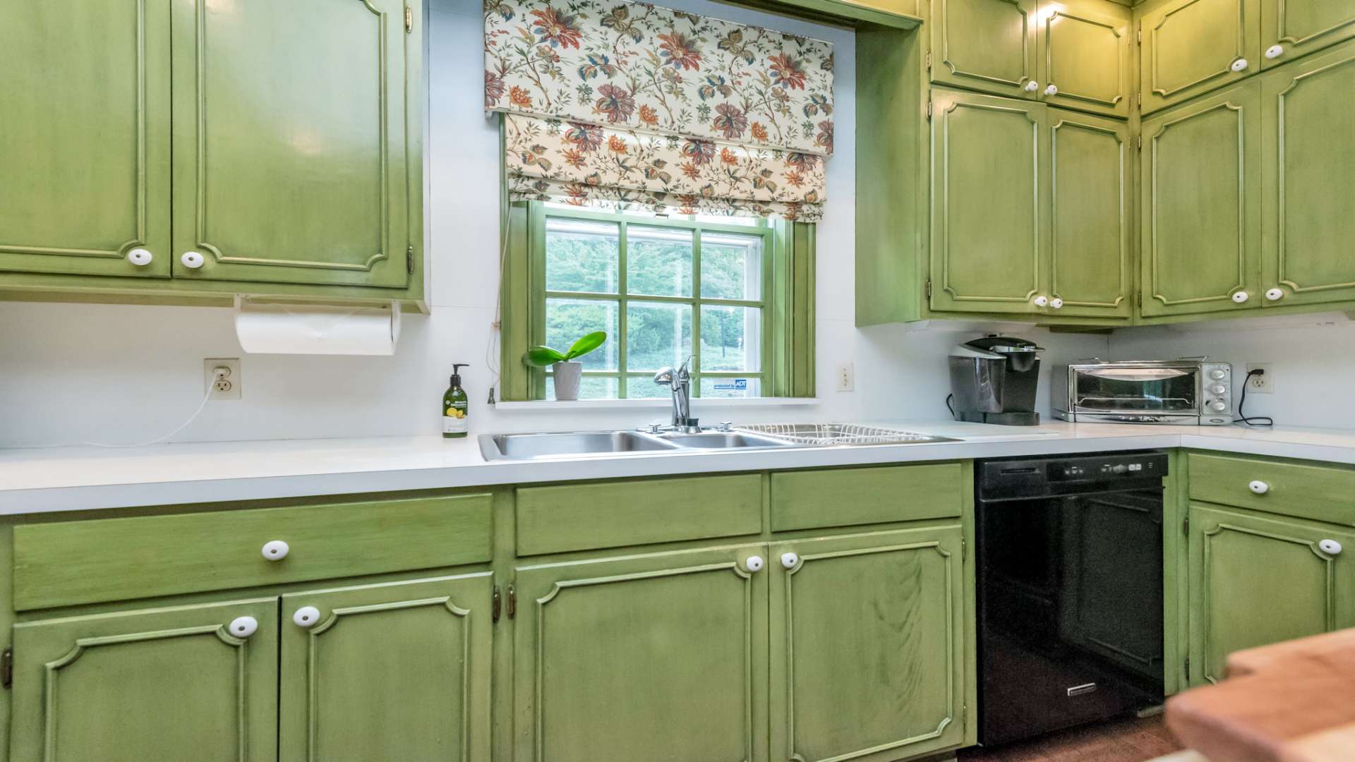 Handcrafted Custom cabinetry providing yet another tribute to the colonial era. Notice the tri-sink area that includes a prep sink.