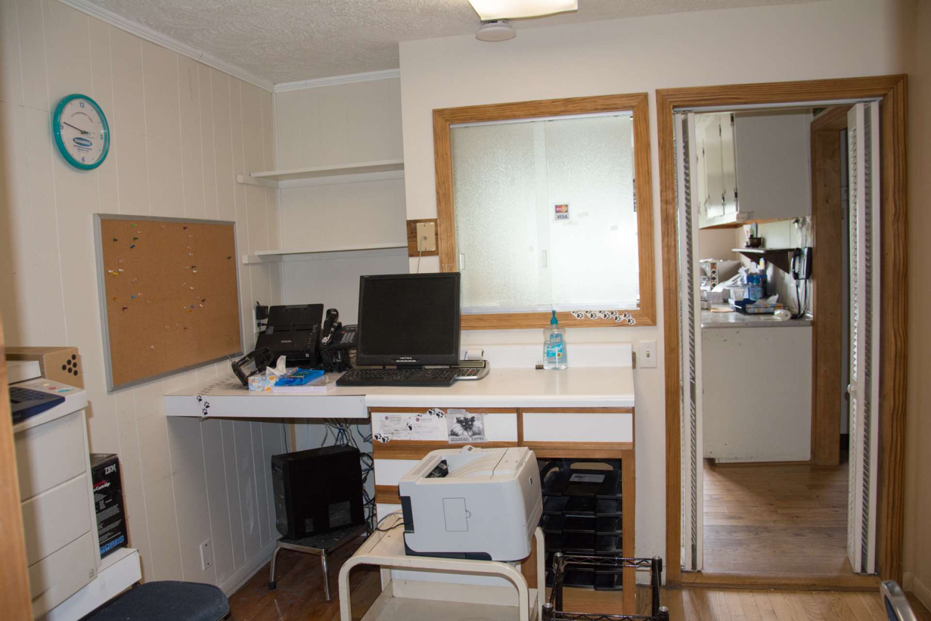 There are two offices with check in or out windows, and a file room with shelving and storage closet.
