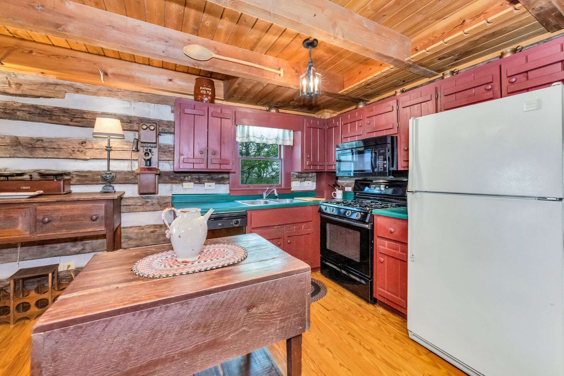 The kitchen features a gas range, dishwasher, and antique island.