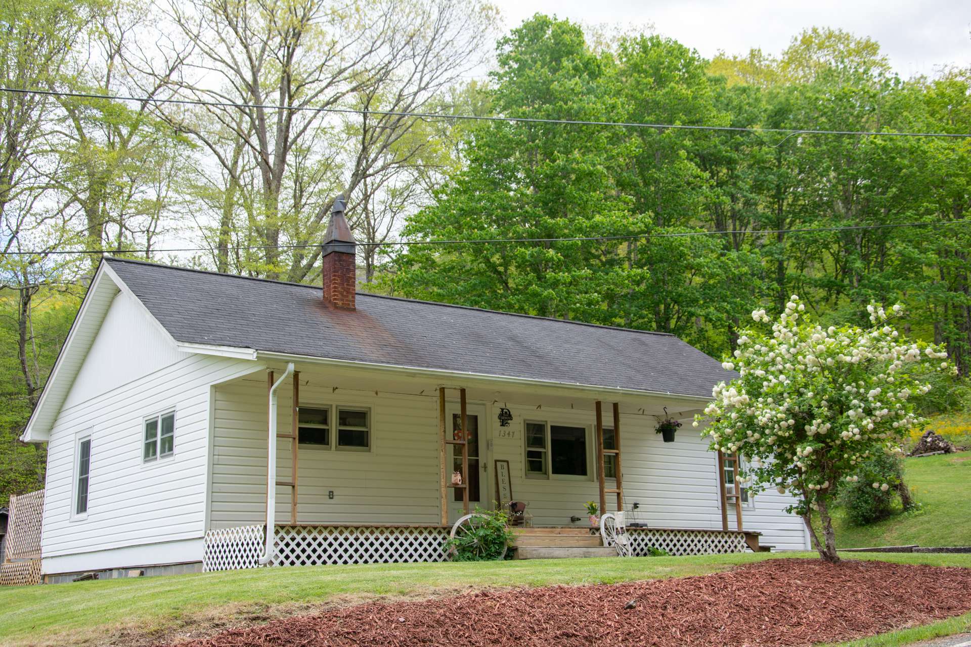 Located on Ed Little Road in the Warrensville area of Ashe County in the North Carolina Mountains, this cozy farmhouse style cottage is only a short walk to the New River.