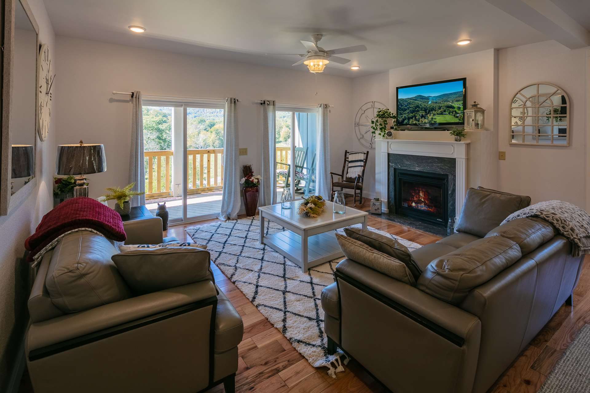 The abundant windows and custom glass doors to access the outdoors fill the home with natural light while the fireplace adds extra warmth on cool winter evenings.