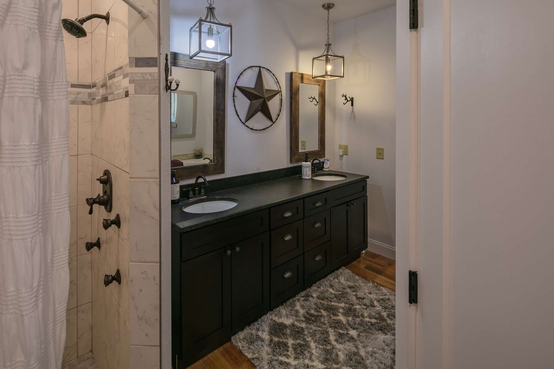 The master bath features a double vanity, leather granite countertop, whirlpool tub and tile shower.