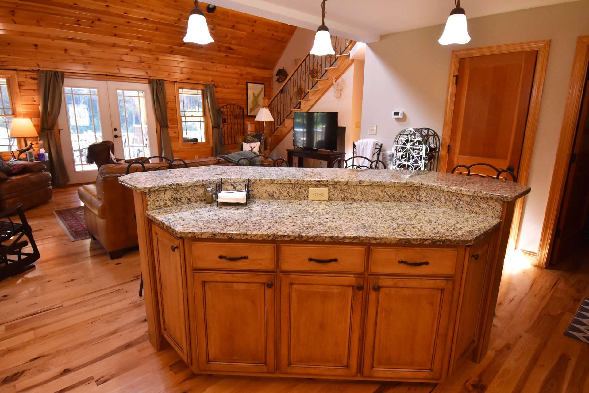 The island cabinets are stained, giving a two-tone kitchen. The back of the island is stone.