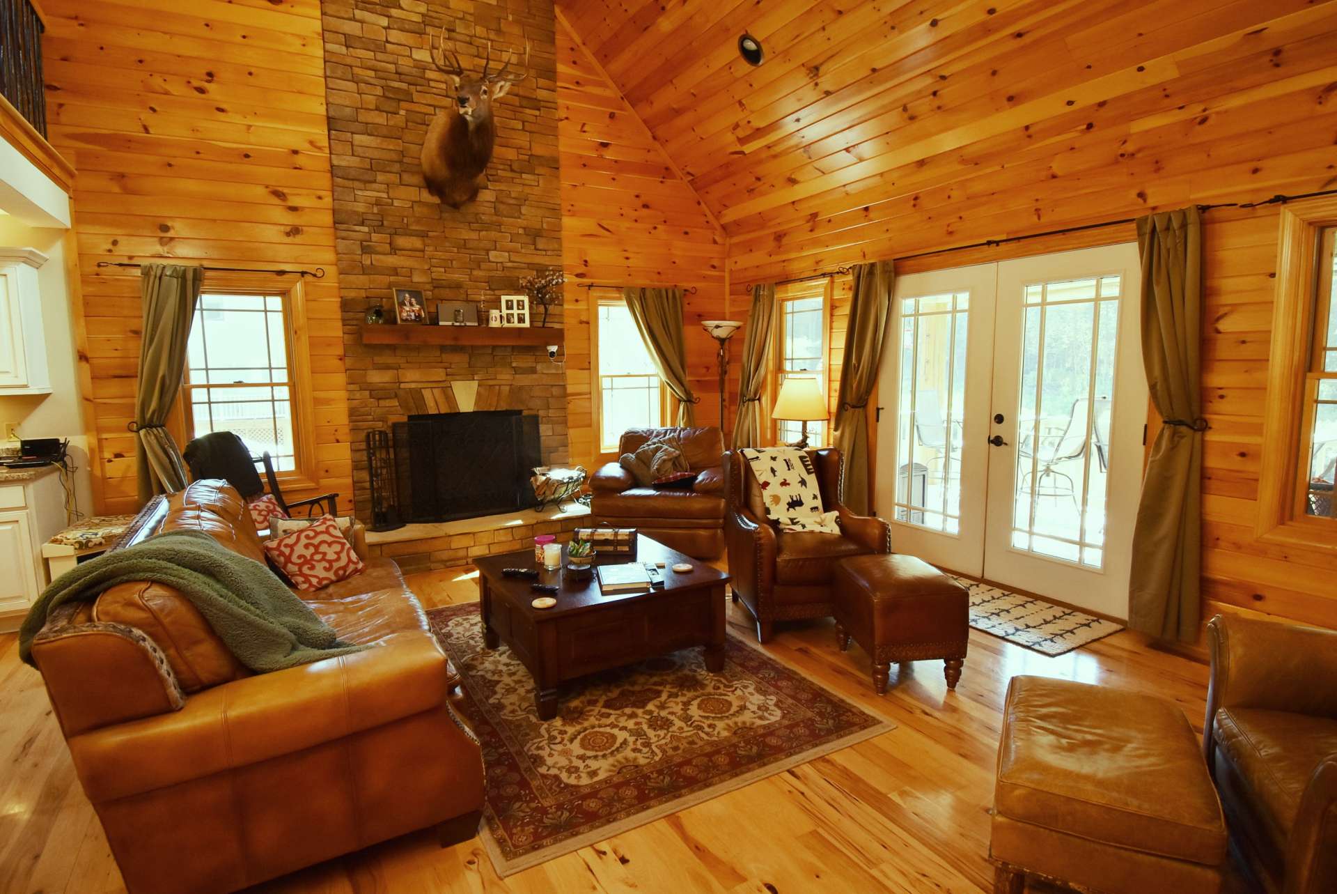 The living room is bathed in light from the many windows, plus the skylights. Doors to the covered porch (the front porch is covered, too) make the outdoors just a step away from every moment of the day.