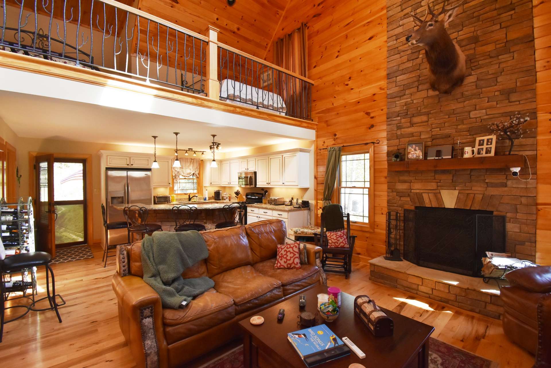 The fireplace is a central feature of the living room.  The open floor plan allows the host or hostess to stay involved in conversation while preparing the meal.