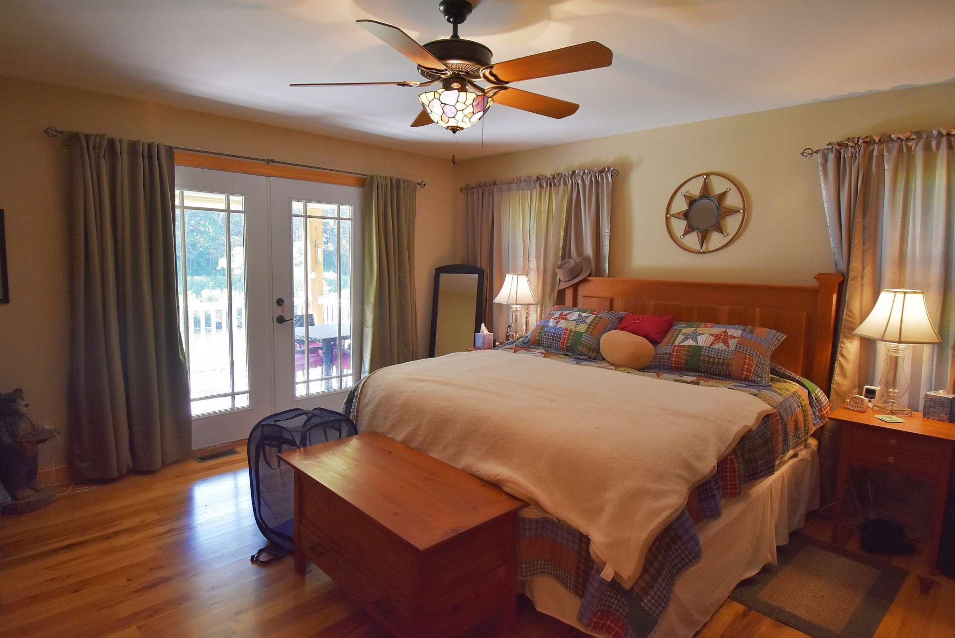 Conveniently located on the main level, the master suite boasts beautiful hardwood flooring, private access to the back deck, and a private bath.