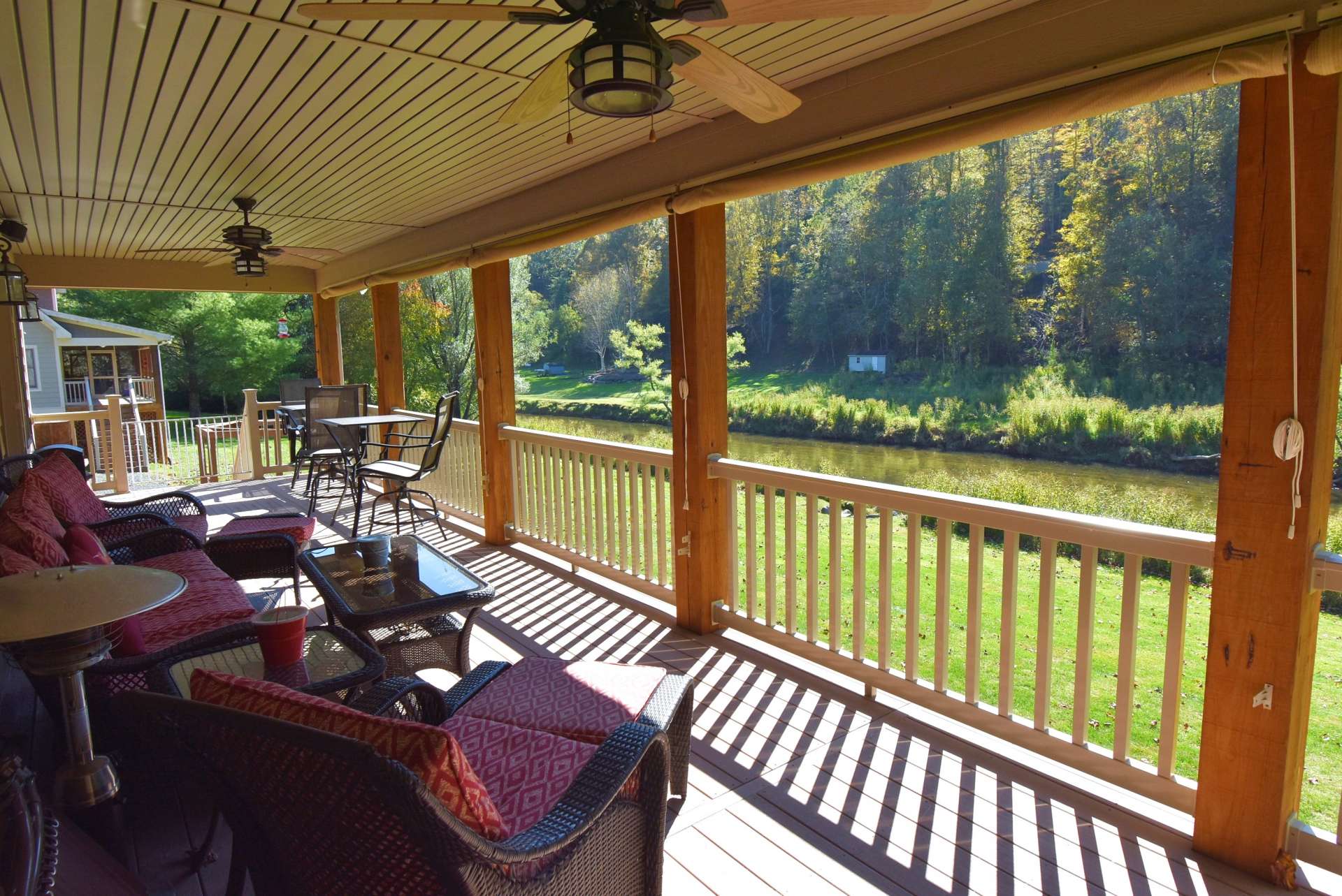 This is the spot! The covered back porch overlooks the level yard and the river just a few feet beyond. This is where you''ll want to settle in to enjoy life in the mountains. Trex decking makes for low maintenance.
