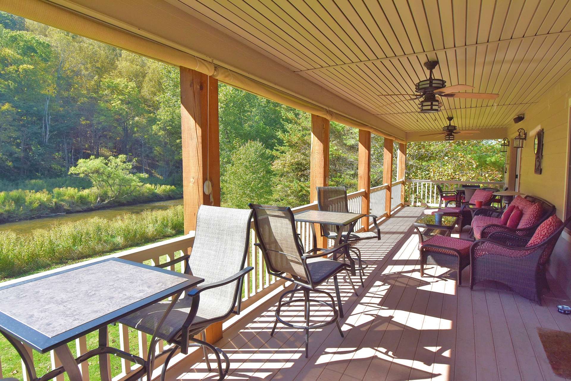 A full length covered back porch is an ideal place for outdoor grilling, dining, and entertaining.  Or simply relax with your favorite drink and  enjoy the river as it flows below.