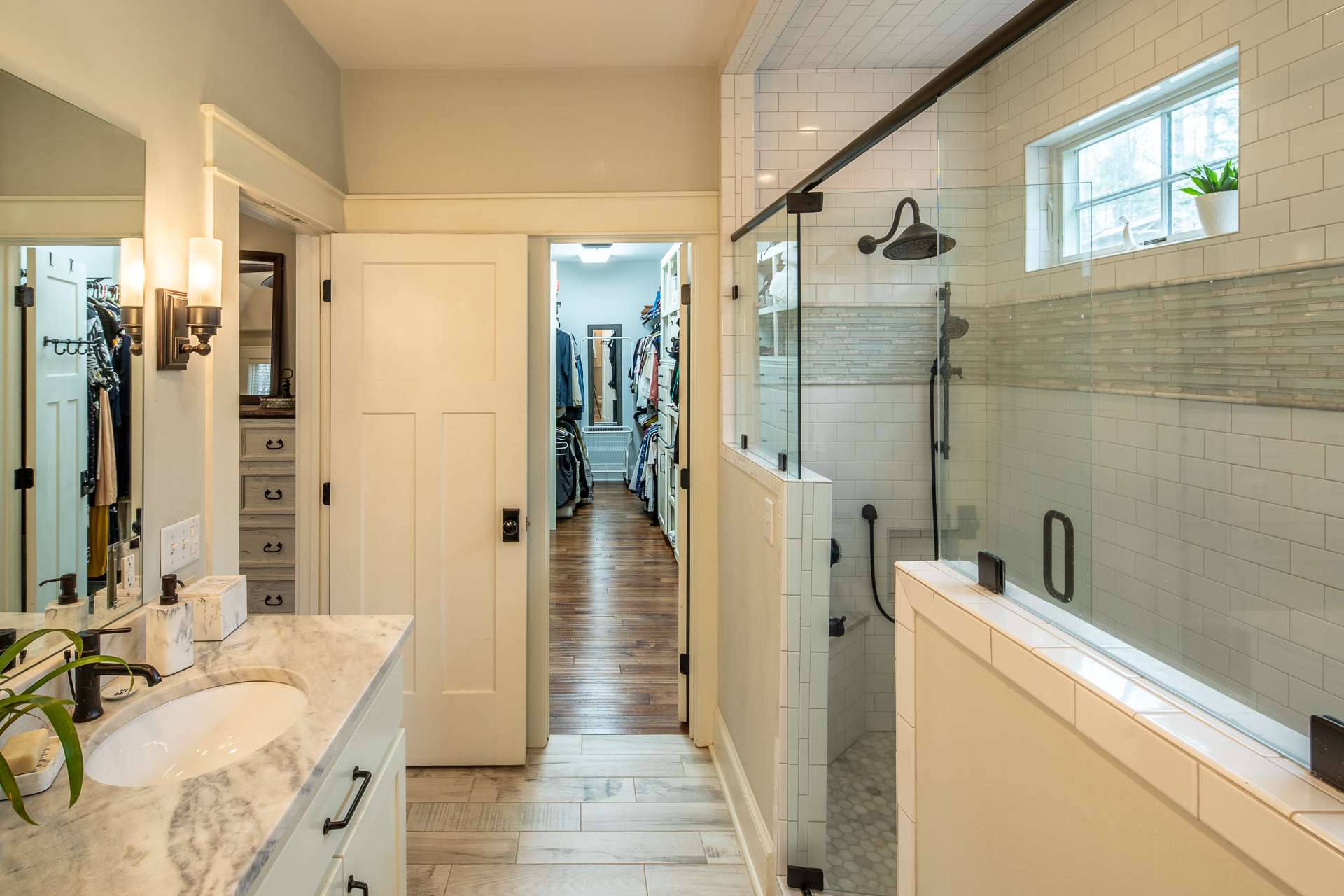 The master bath is nice & bright and offer separate sinks, ample countertop & storage space and a generous size tile shower with four shower heads.