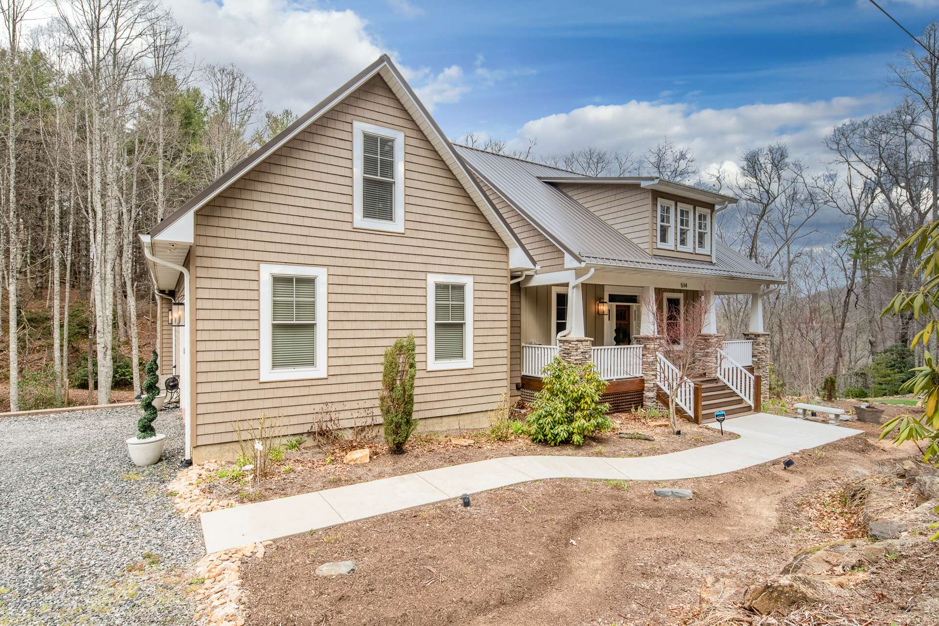 The yard is beautifully landscaped in front with large boulders and native plants and shrubs. From the back deck, enjoy complete privacy and a view into the forest of towering trees.