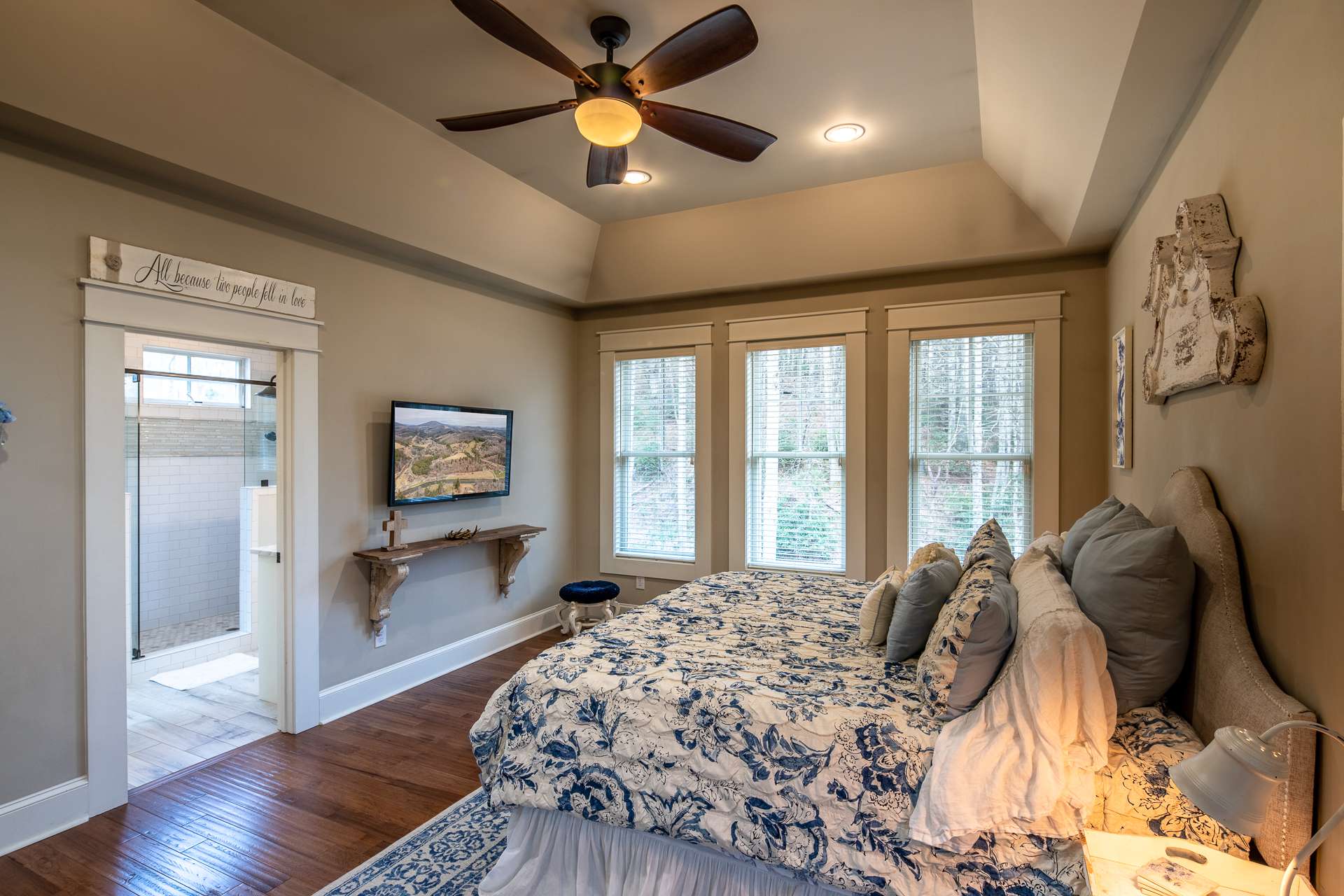 The master suite is situated for privacy and features a tray ceiling and private bath with  huge walk-in closet with built-in storage and dressing table.