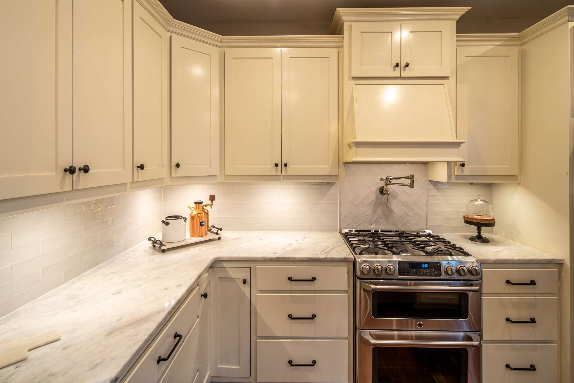 Enjoy custom white cabinetry designed to hide all your small appliances, granite counter tops, stainless appliances including gas range with dual fuel double oven and pot filler and Legrand under cabinet lighting system.
