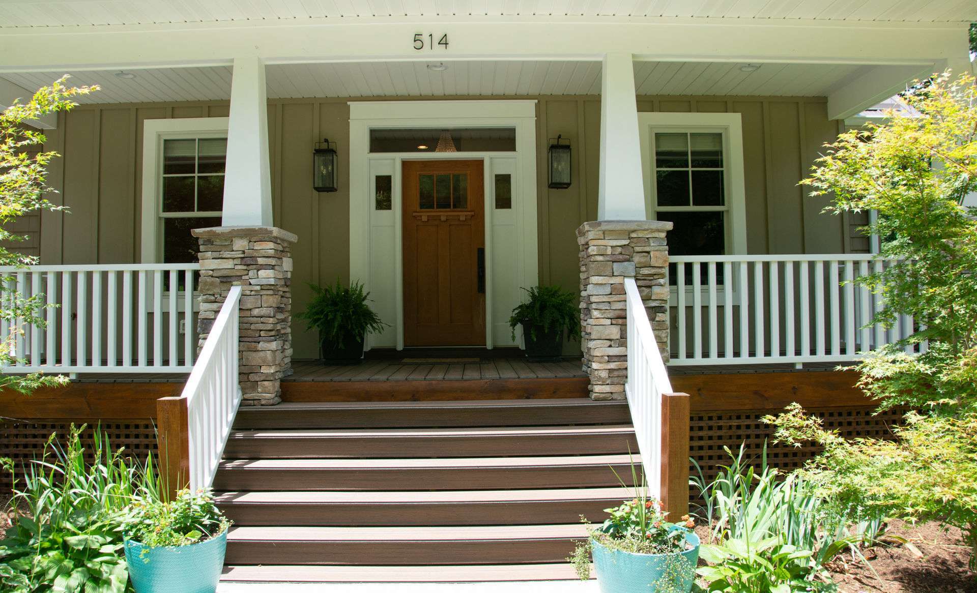 A covered front porch invites all to  enter this custom home and experience mountain living at its finest.