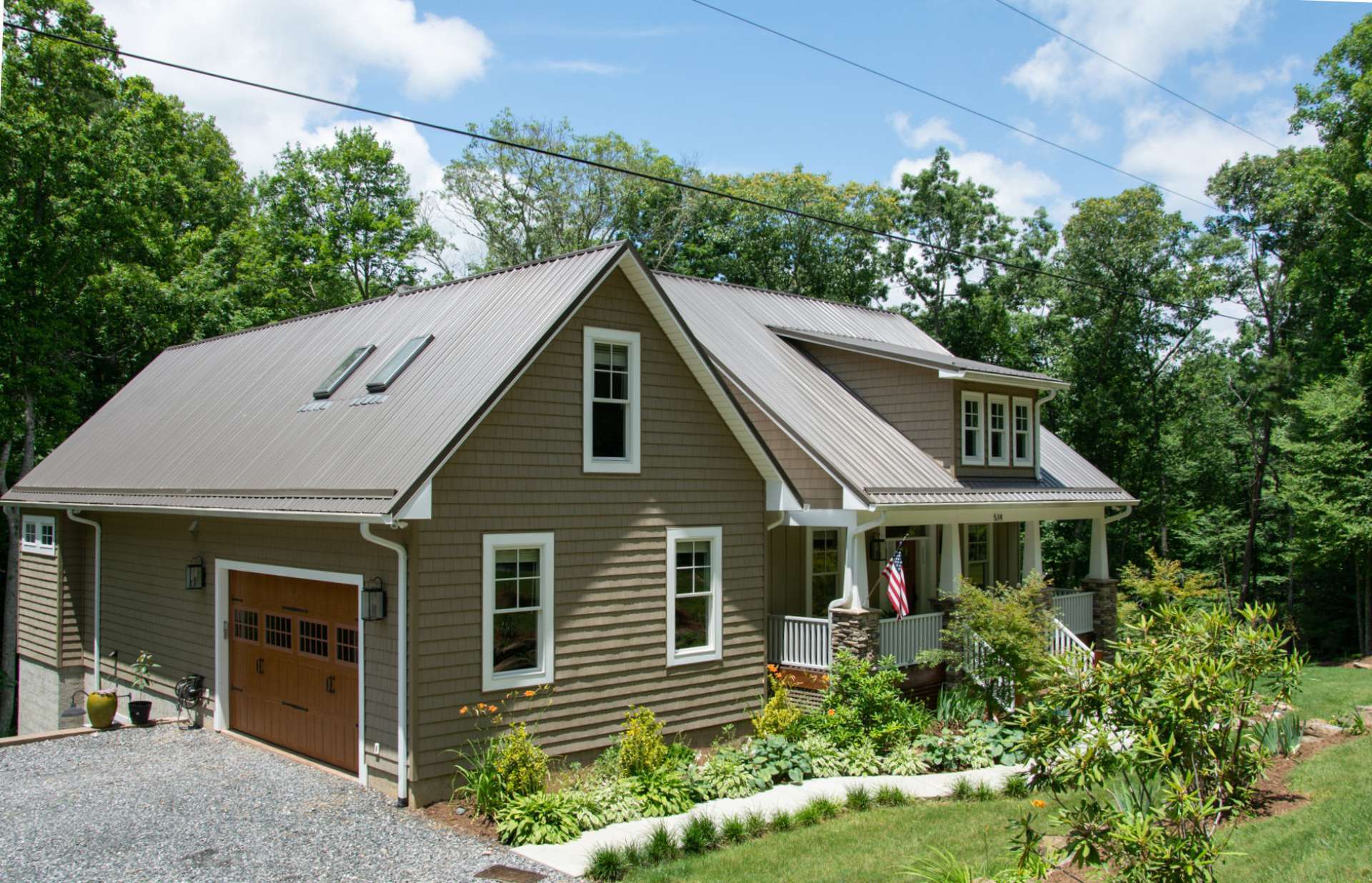 The yard is beautifully landscaped in front with large boulders and native plants and shrubs. From the back deck, enjoy complete privacy and a view into the forest of towering trees.