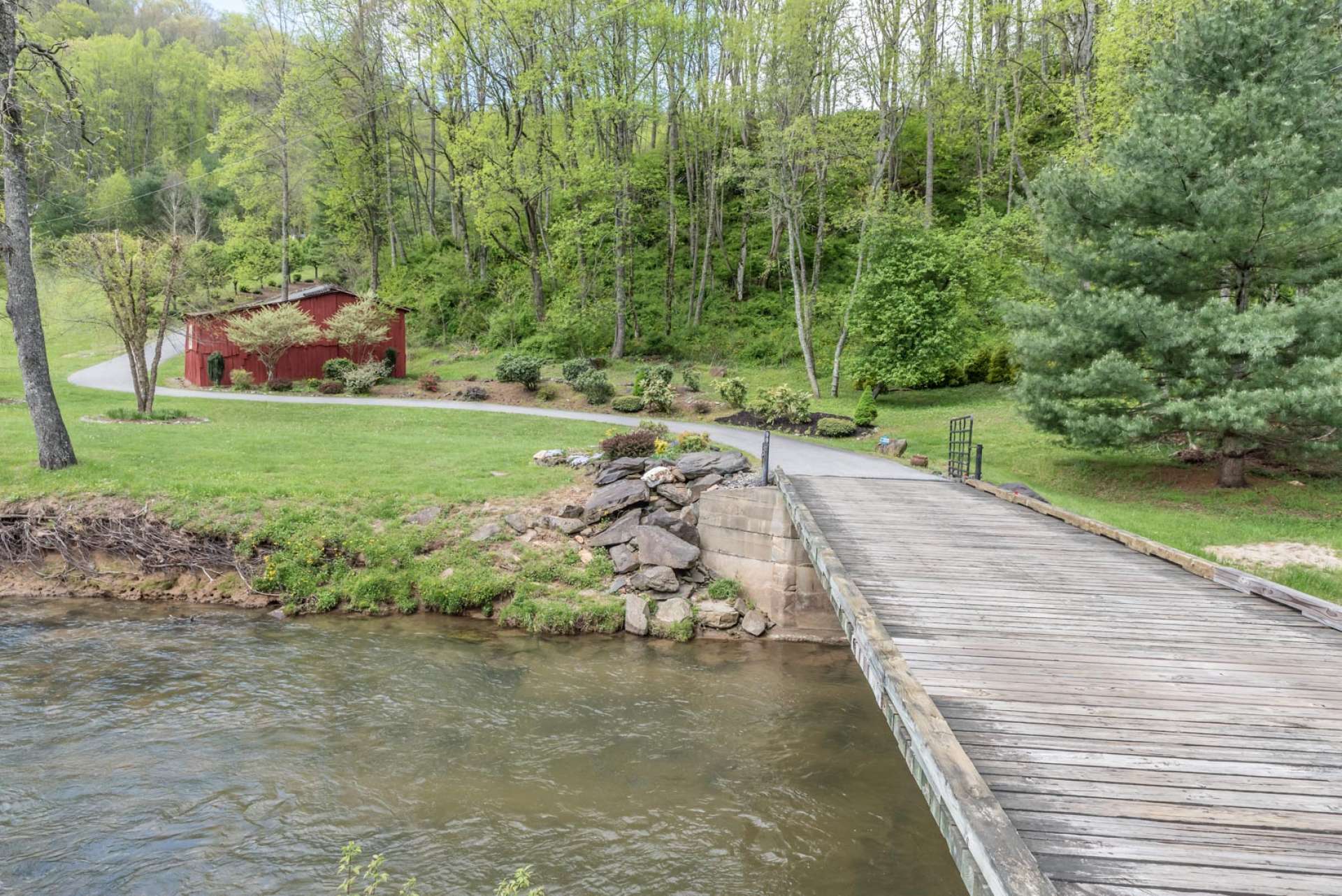 A picturesque setting accessed via a bridge across the creek and a paved drive through pristine acreage.