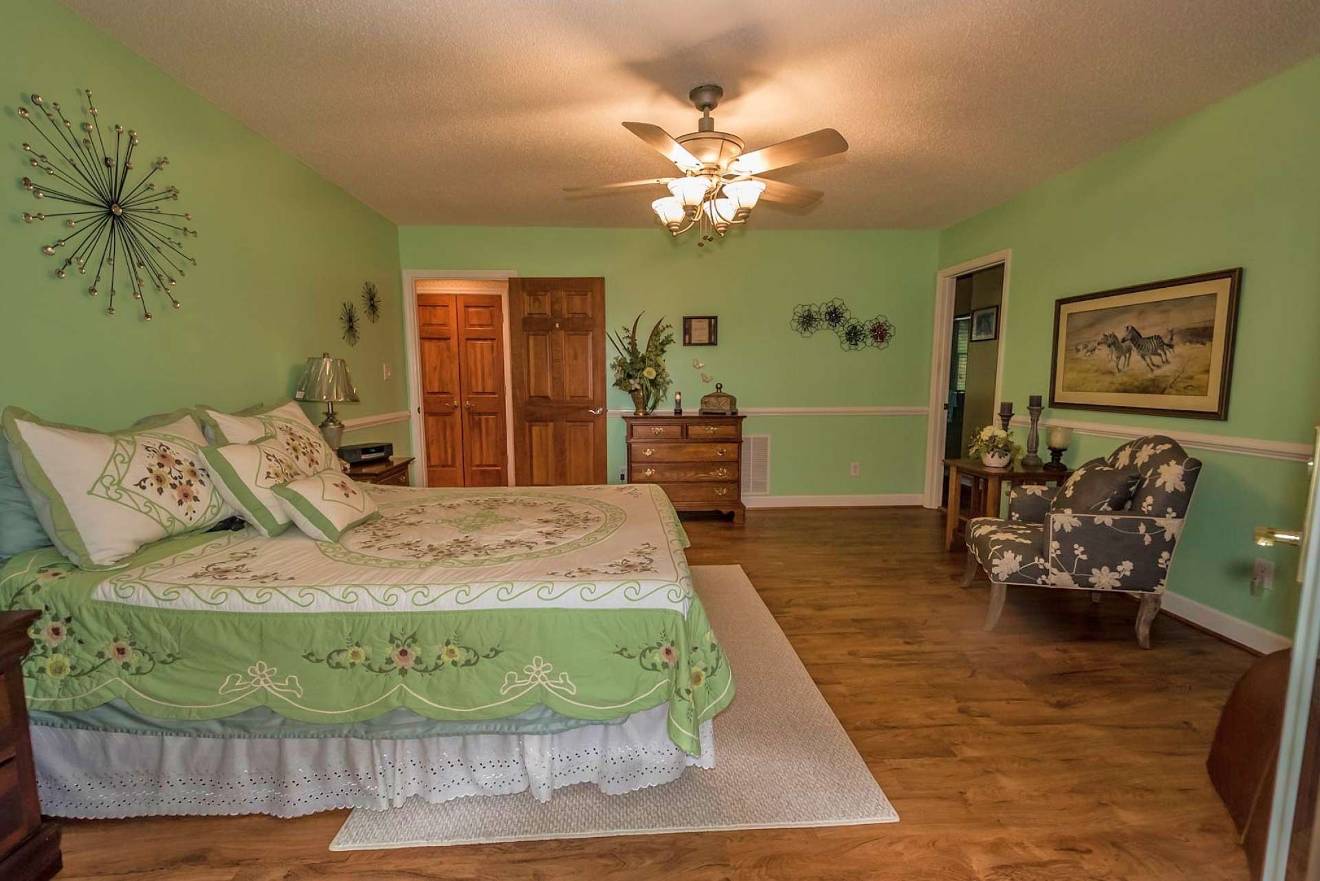 The main level offers two choices for your master suite. This spacious option offers wood floors, walk-in closet, private bath with double vanity, and access to the covered porch.