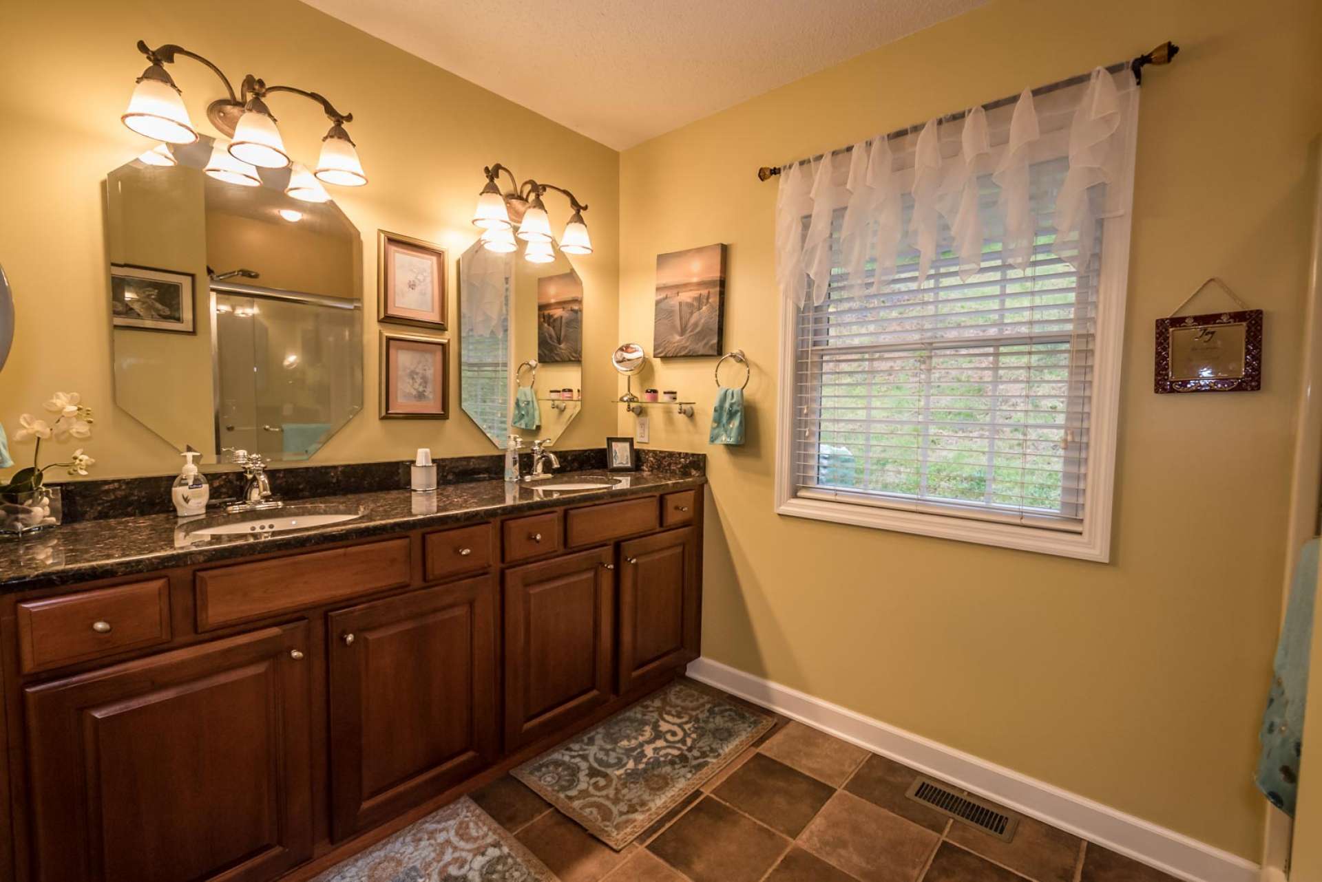 This spacious master bath offers tiled floor, double vanity with granite counter, and walk-in shower.