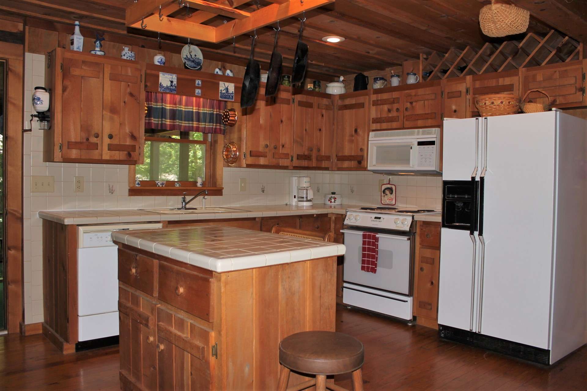 The bright kitchen with tiled backsplash and center island offers abundant storage and prep space.