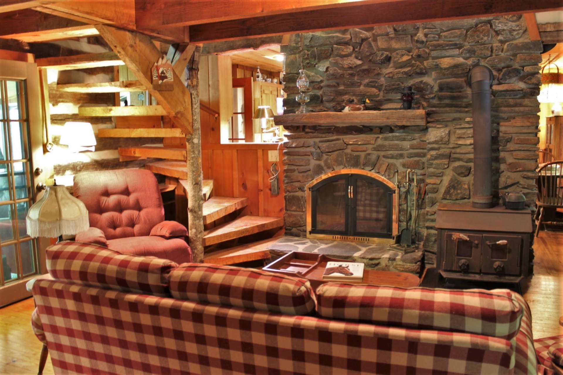 Choose either the native stone wood-burning fireplace that reaches up to the raised ceiling or the more efficient wood burning stove to heat the cabin during cold winter nights.