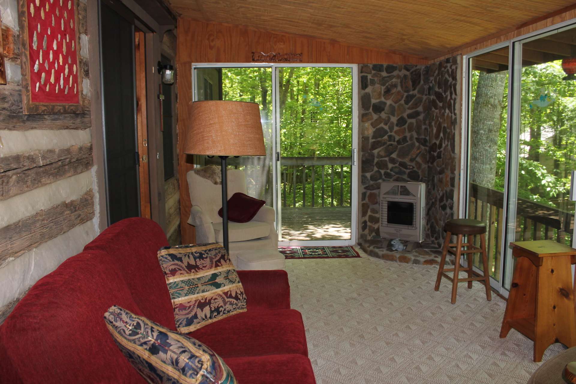 This unique sun room is equipped with sliders on three sides to take in the views and sounds of the backyard and creek. A propane heater allows use even during the winter months.