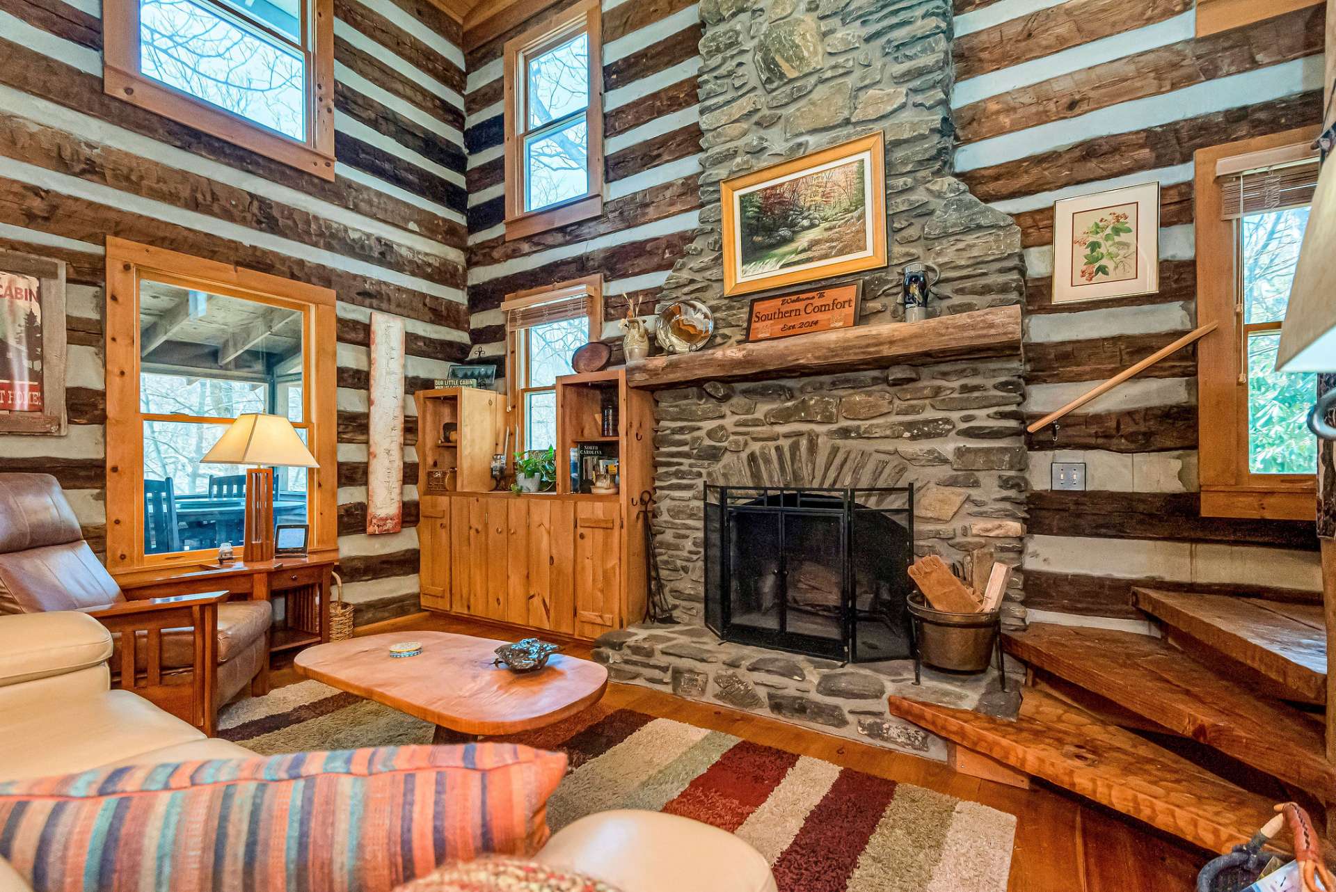 Enjoy the ambiance of the living room with it's vaulted wood ceilings and majestic floor-to-ceiling native stone fireplace.