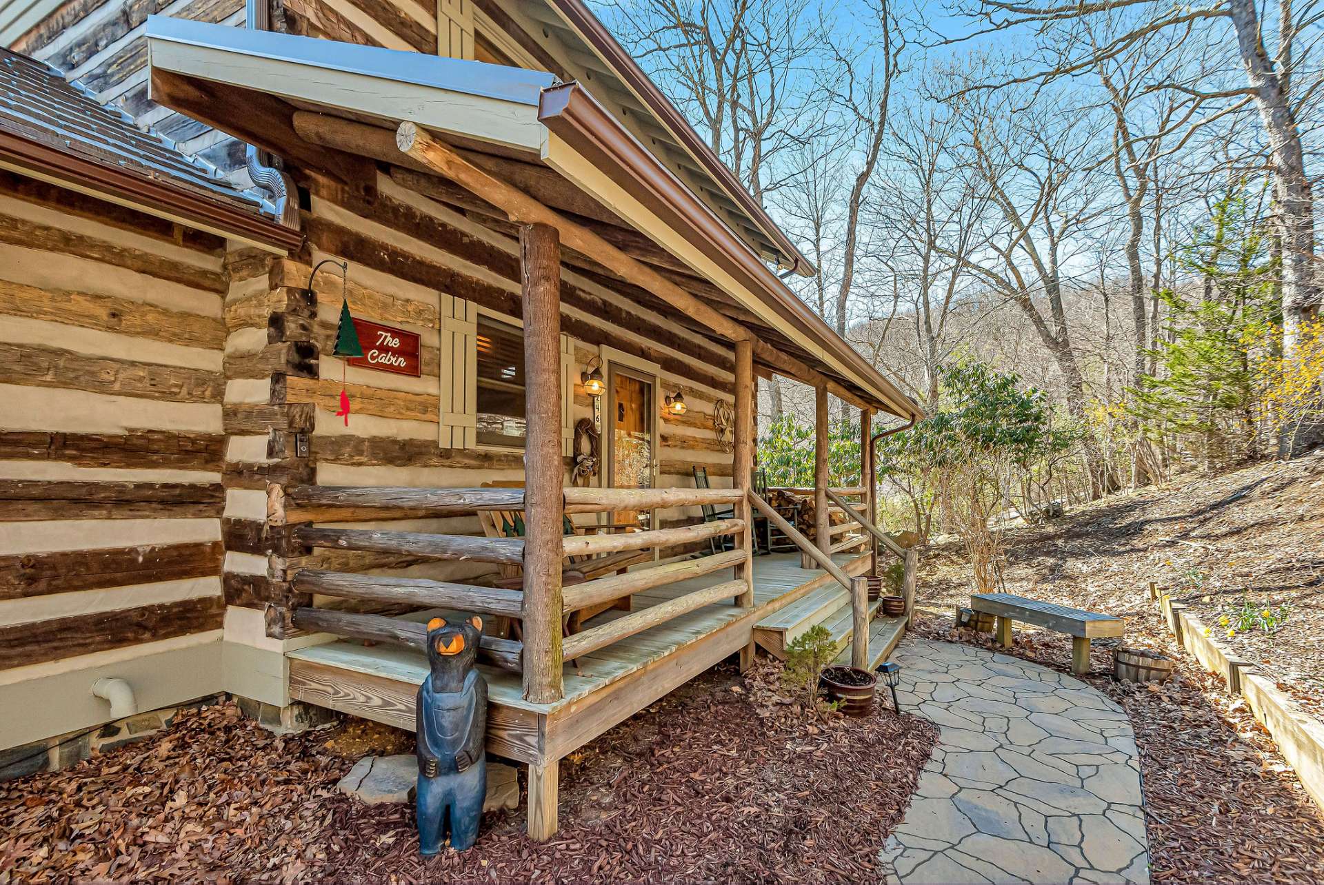 A newly laid stone walkway offers a seamless path to the indoors.