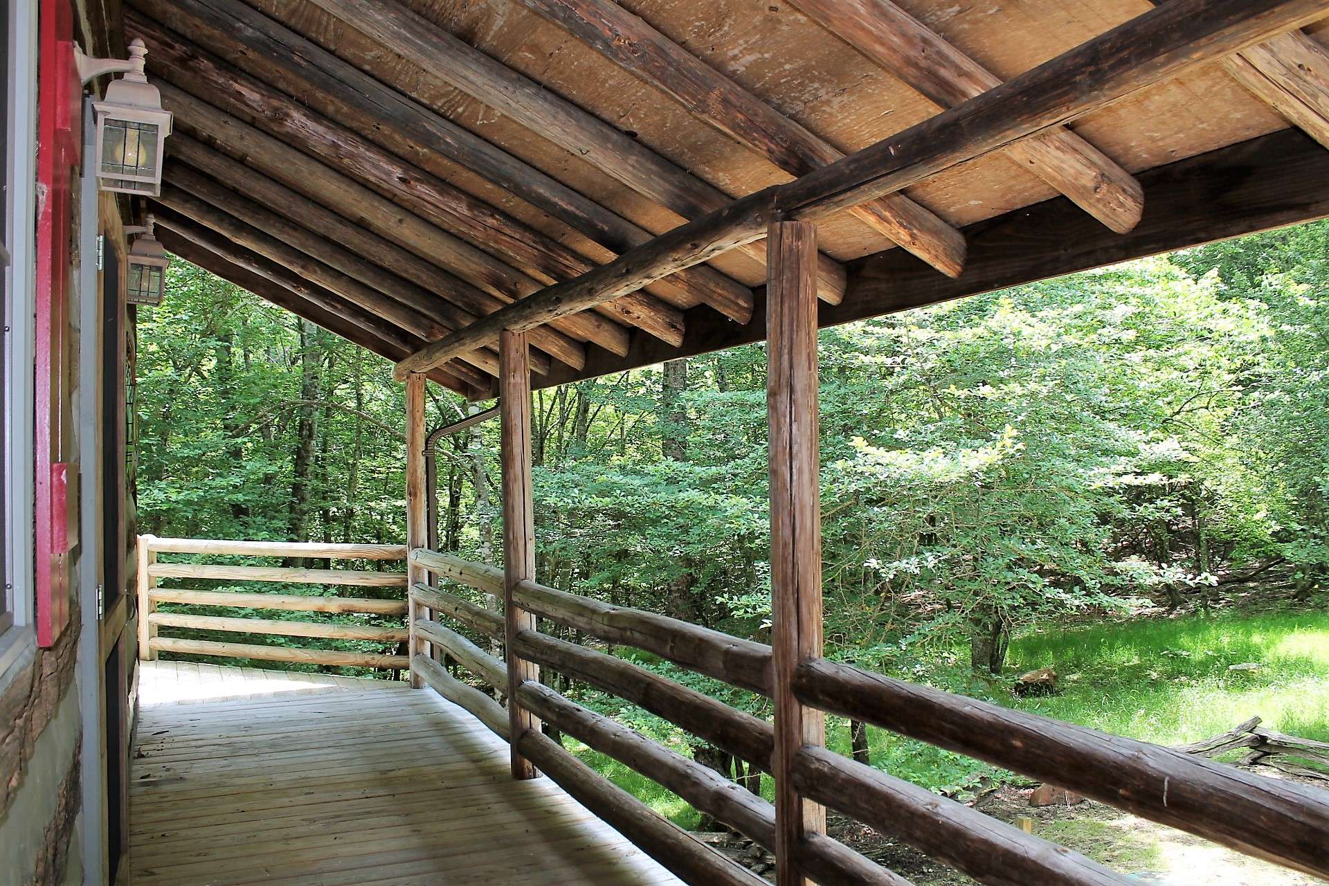 A covered front porch welcomes you and guests to relax a bit and enjoy the peaceful surroundings before entering the home.