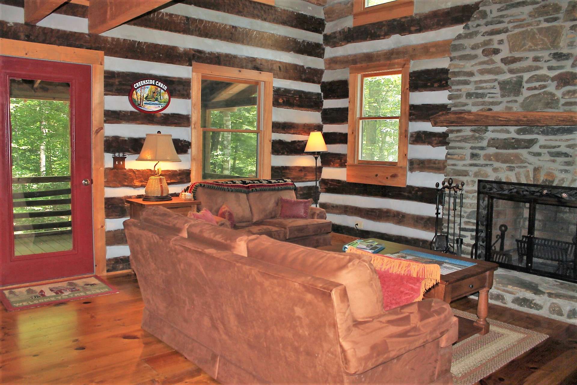 Enter into the warm and inviting great room where a two story fireplace hand crafted with native stone and flanked by windows will keep you toasty warm during the cooler months.