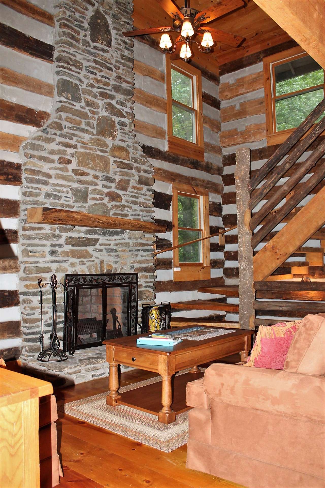 A hand hewn stair case leads to the upper and lower levels.