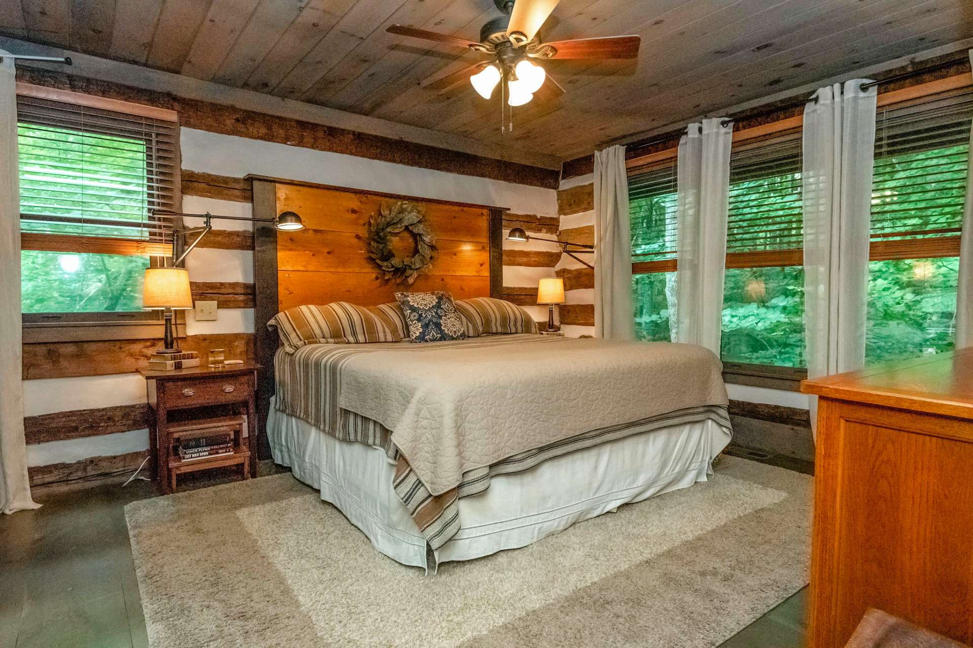 This stunning master suite offers a place to unwind and listen to the creek from the comfort of your bed.