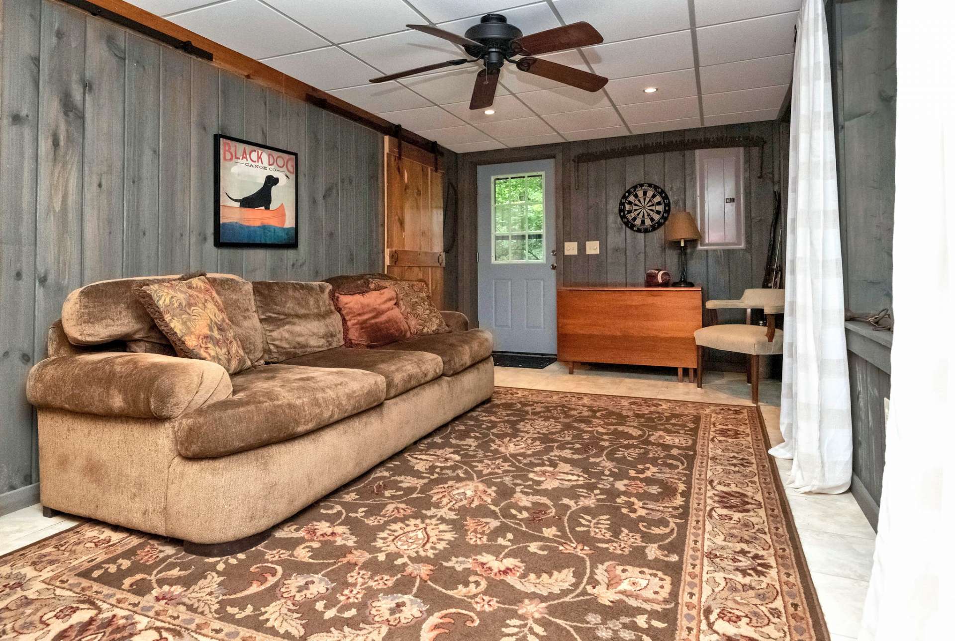 Den on the lower level offers additional space for a sleeping area or just spread out and enjoy your cabin on the creek.