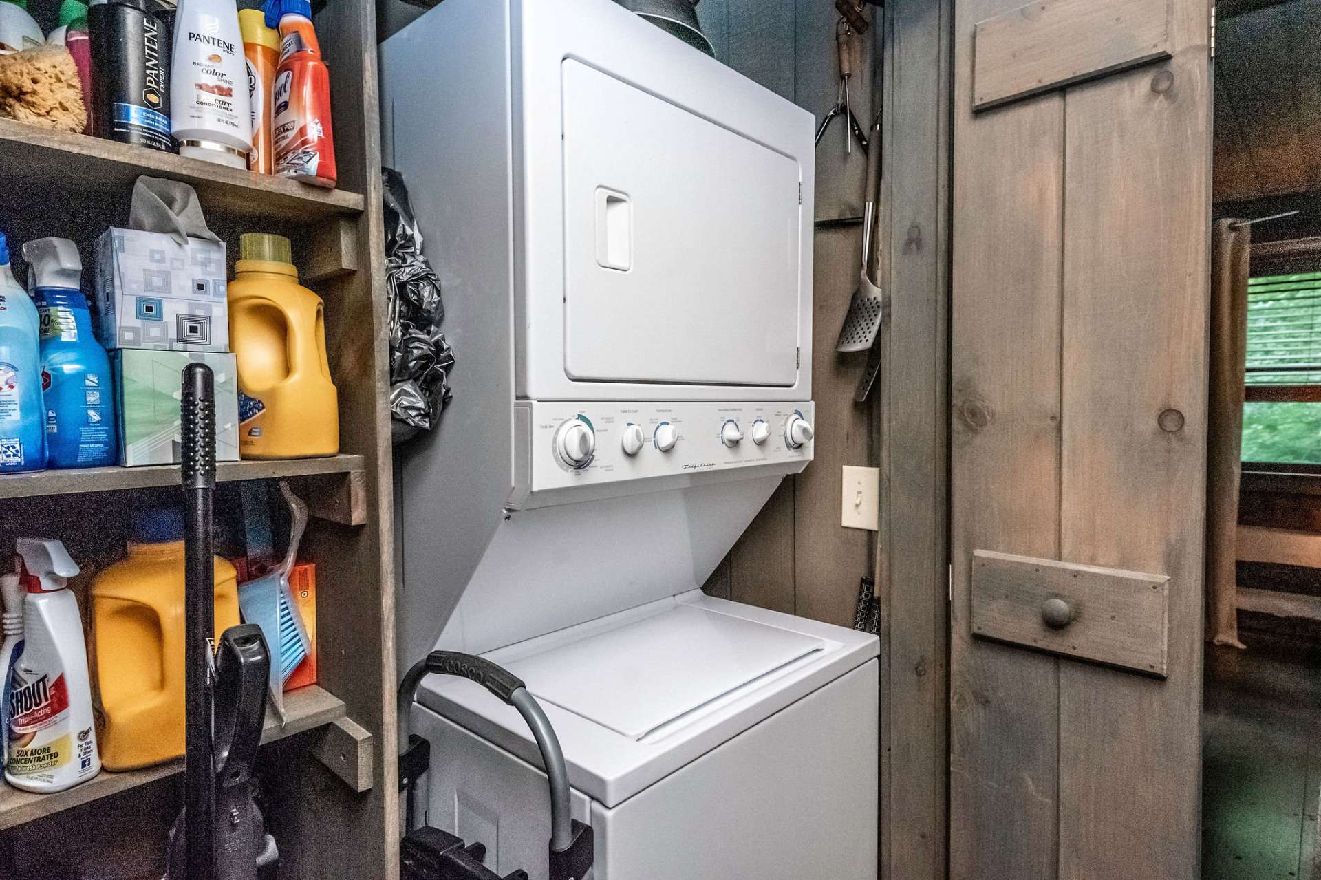 Main level laundry in hallway conveniently outside of the master stays hidden behind the distinguishing designed Stonebridge doors.