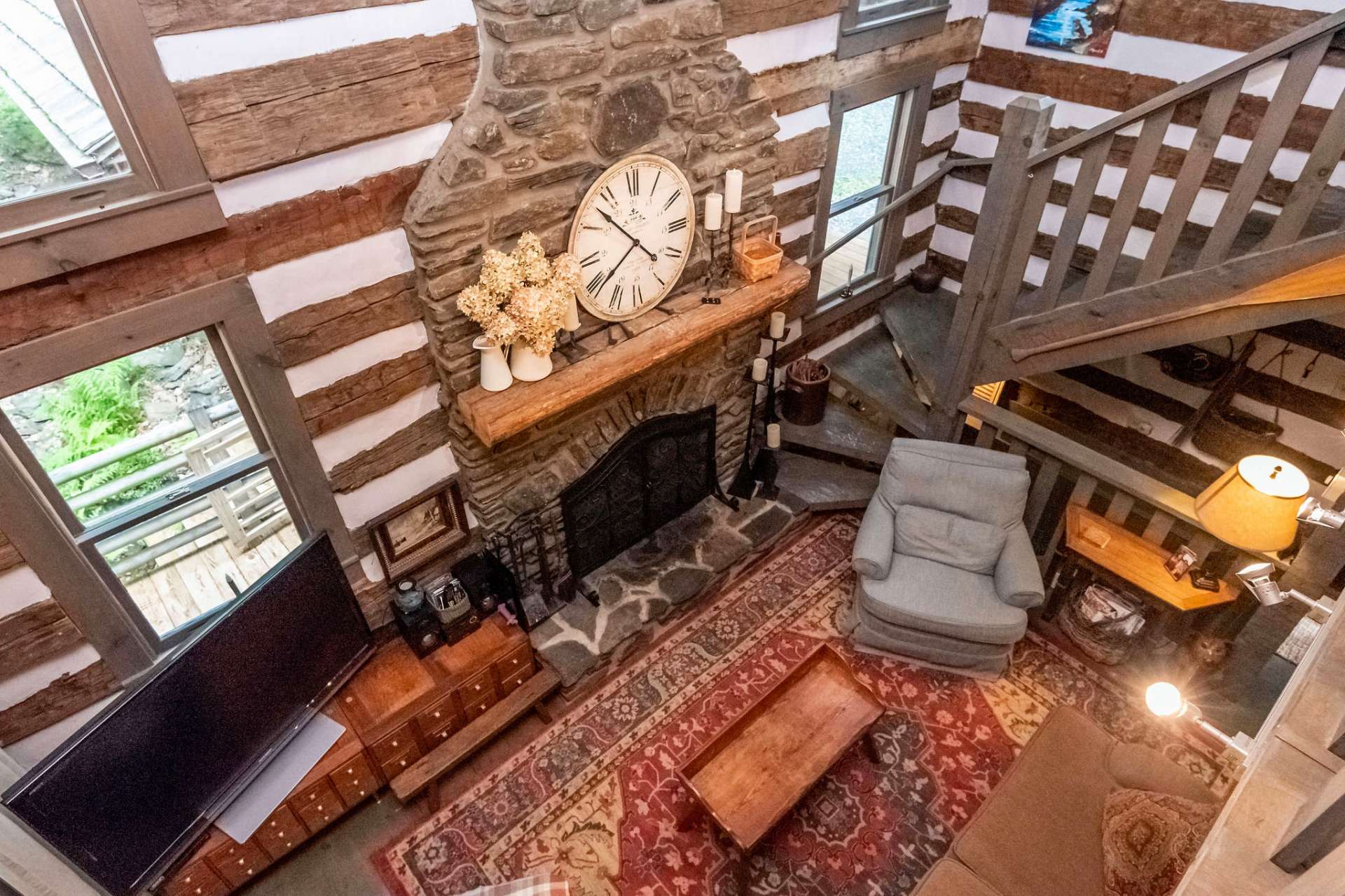 The open loft offers a birds eye view of the living room and massive two story fireplace.