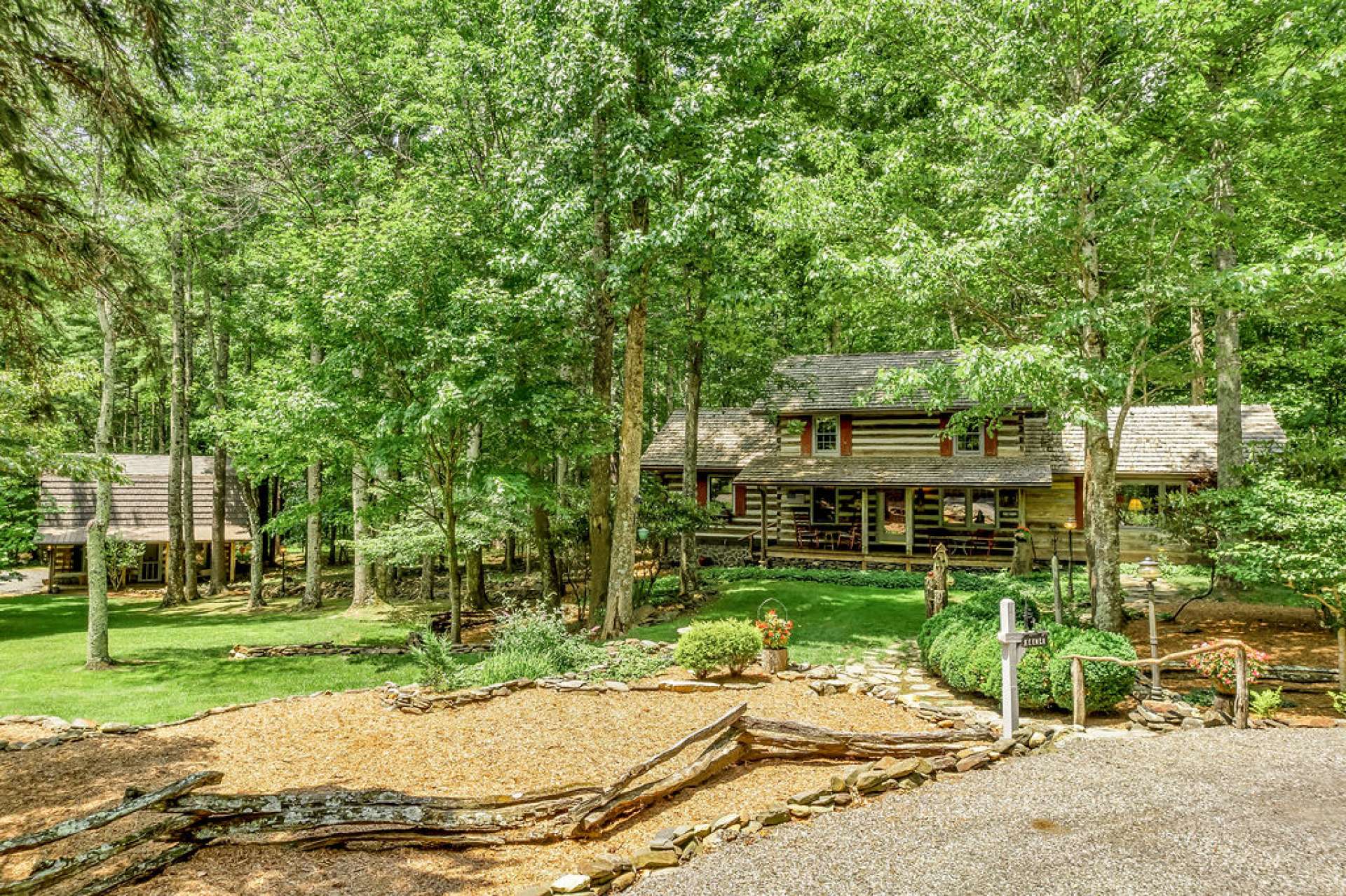 This property is flanked with mature trees blended with flagstone paths leading you down a path of lush foliage to the front door.