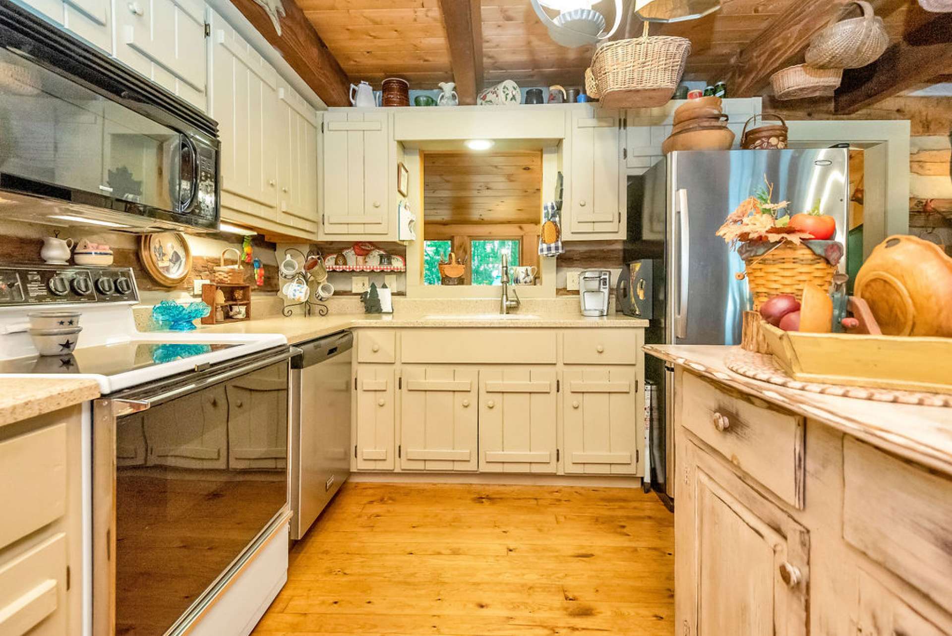 The painted cabinets and light solid surface countertops add a pop of brightness to the room.