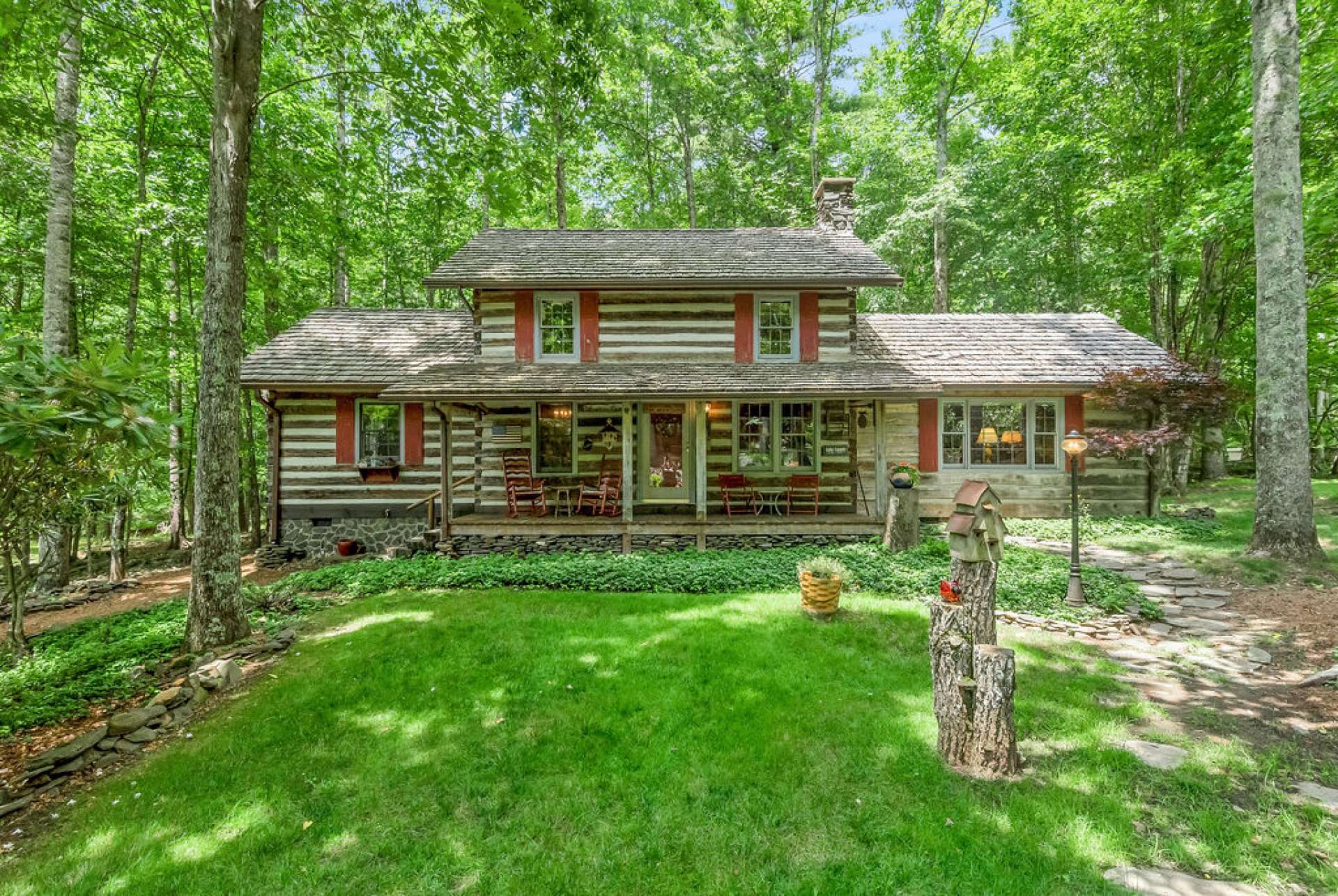 The beautifully landscaped yard sets the stage for this charming home.