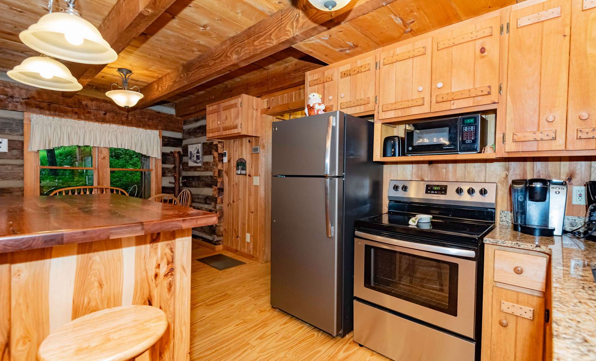 The efficient kitchen area offers stainless appliances, granite counters, and center work island with additional seating.