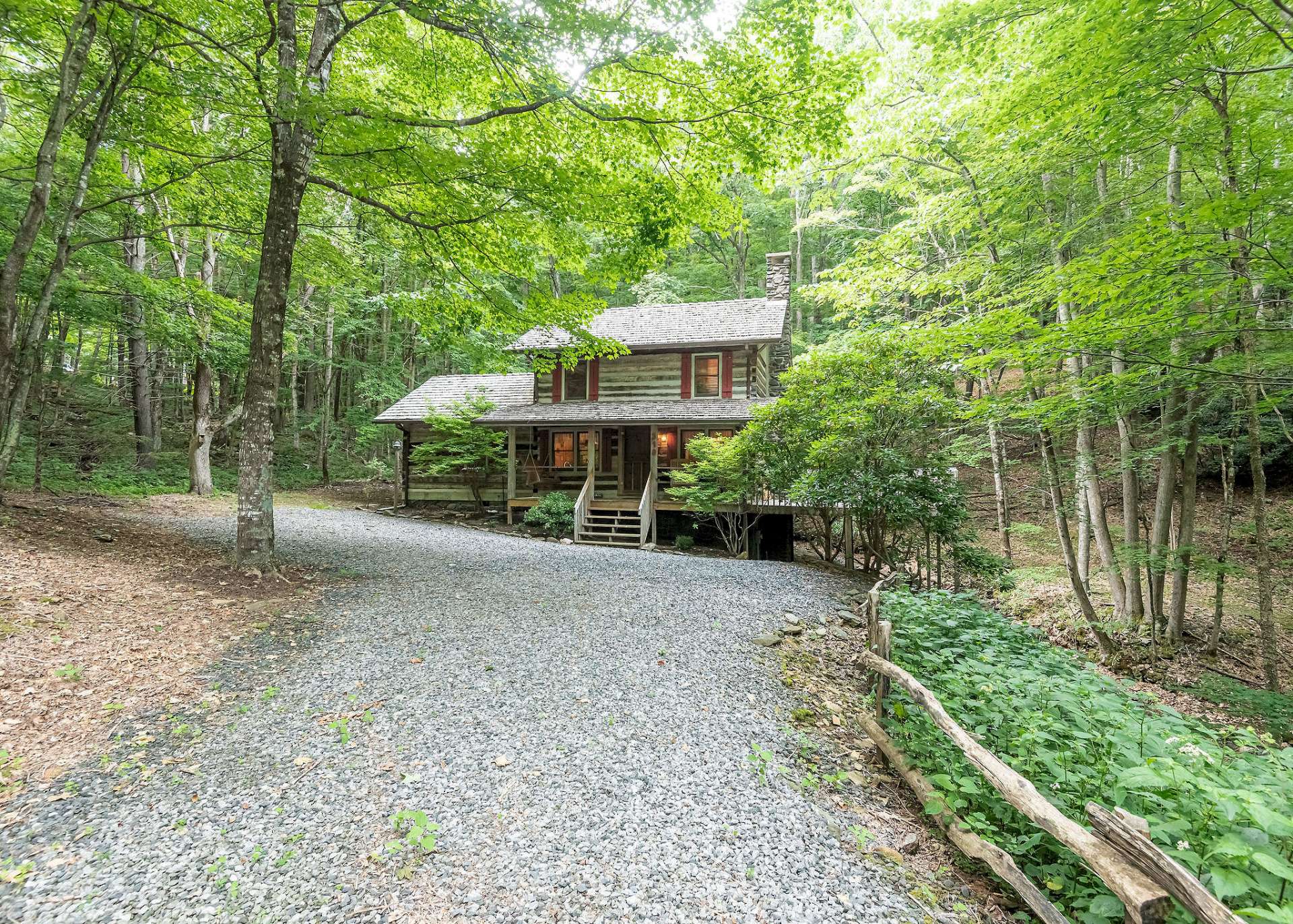 Tucked away in a wooded setting in the highly sought after log cabin community of Stonebridge, this 2-bedroom, 2-bath log cabin offers the true log cabin living experience and located in the Todd area of Southern Ashe County.