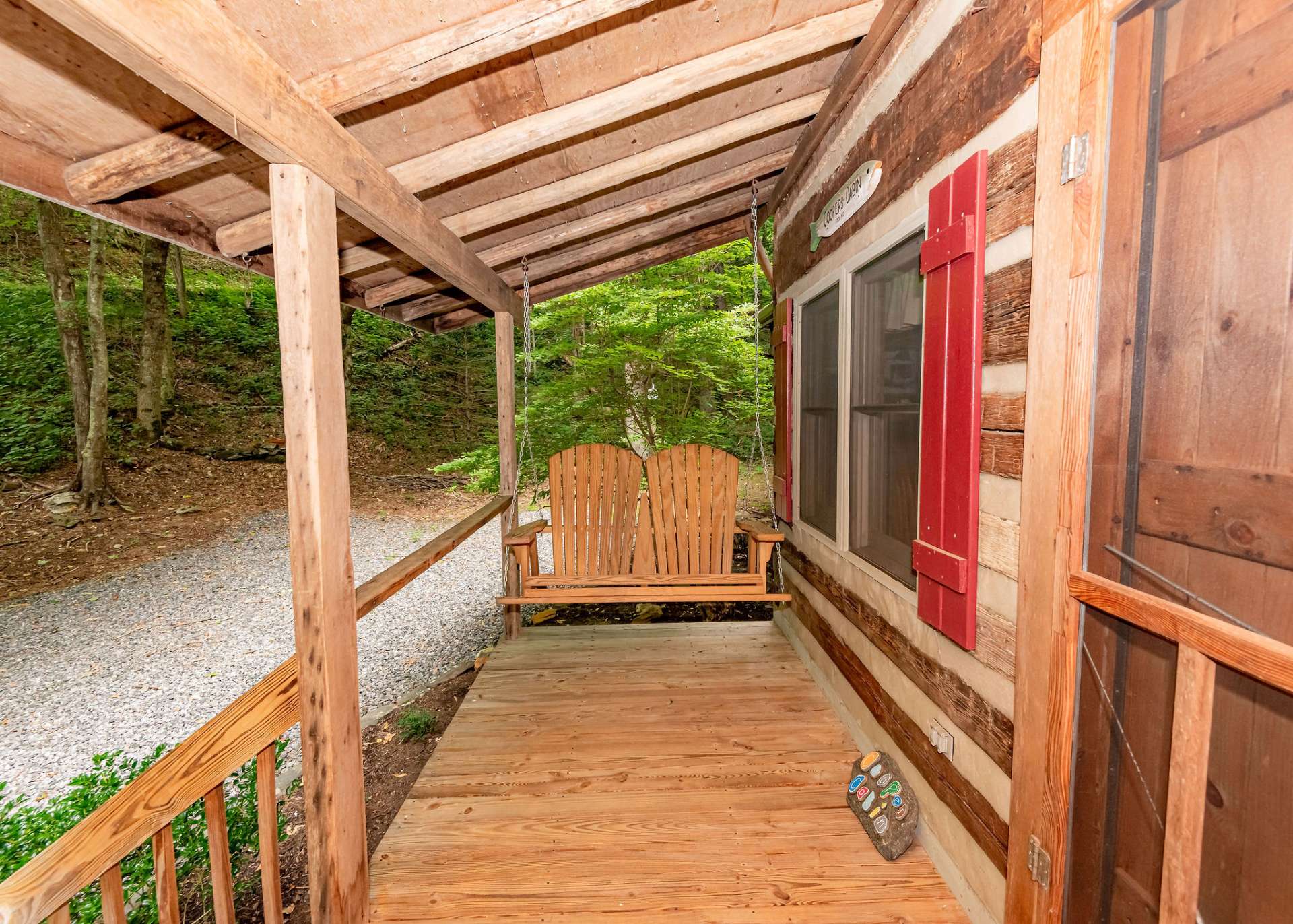 A covered front porch welcomes you and guests to relax and enjoy Nature and mountain living.