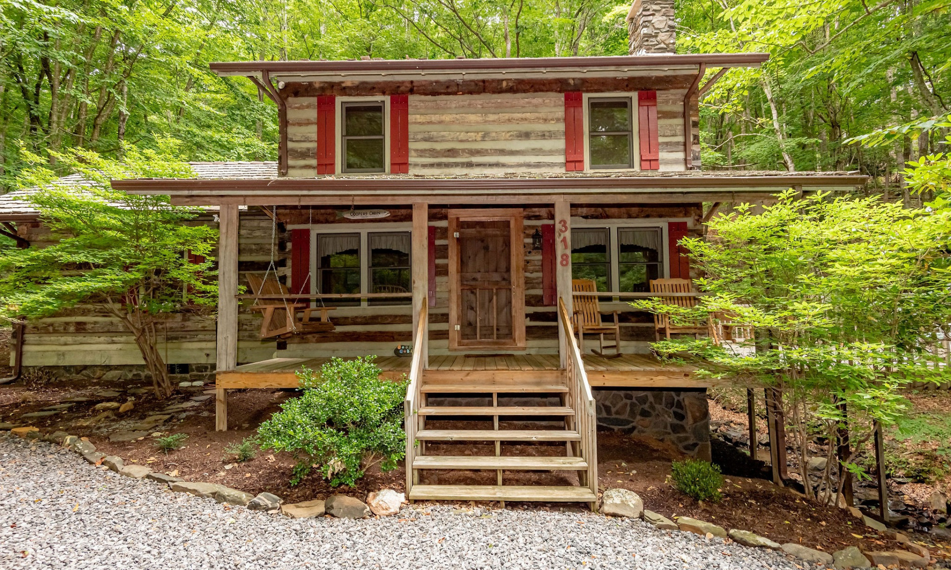 Have you been longing for the true log cabin living experience?  Take a look at this charming antique log cabin with a noisy mountain creek flowing along the back yard.