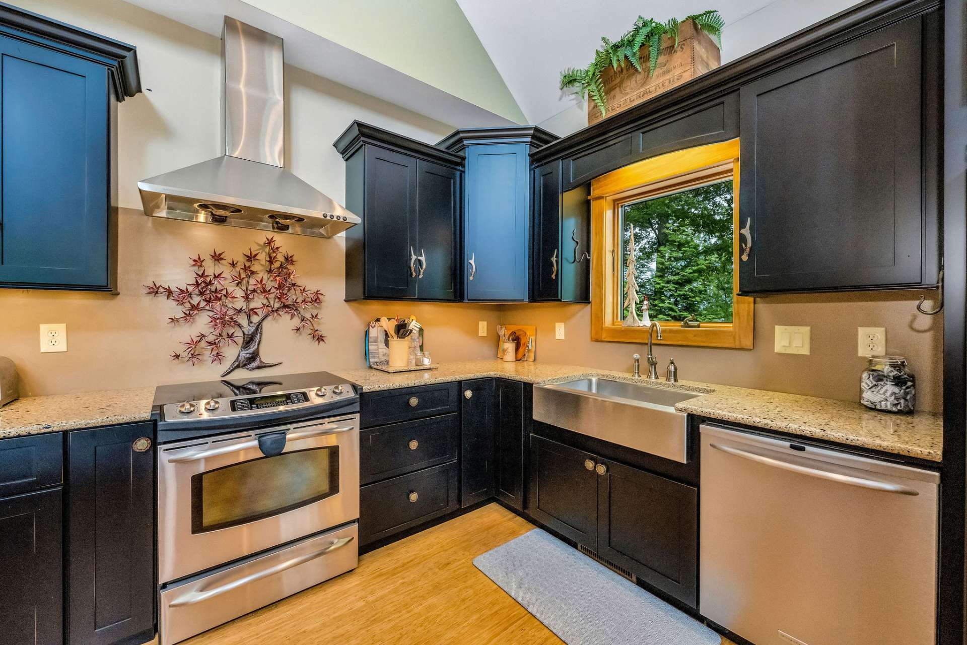 Stainless appliances complement the black cabinets.
