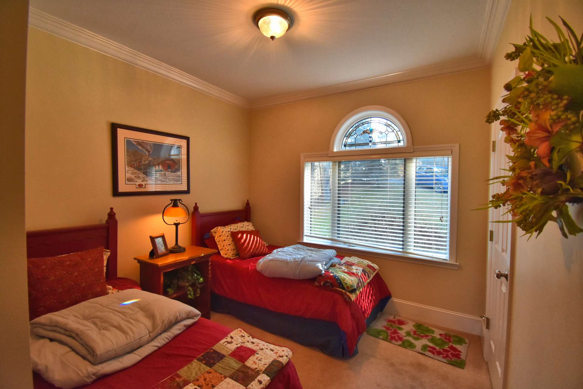 Beautiful hardwood floors lead to the laundry area, two bedrooms, the master suite, another full bath and access to the lower level.  Notice the natural light streaming through the large windows in the first of two guest bedrooms.